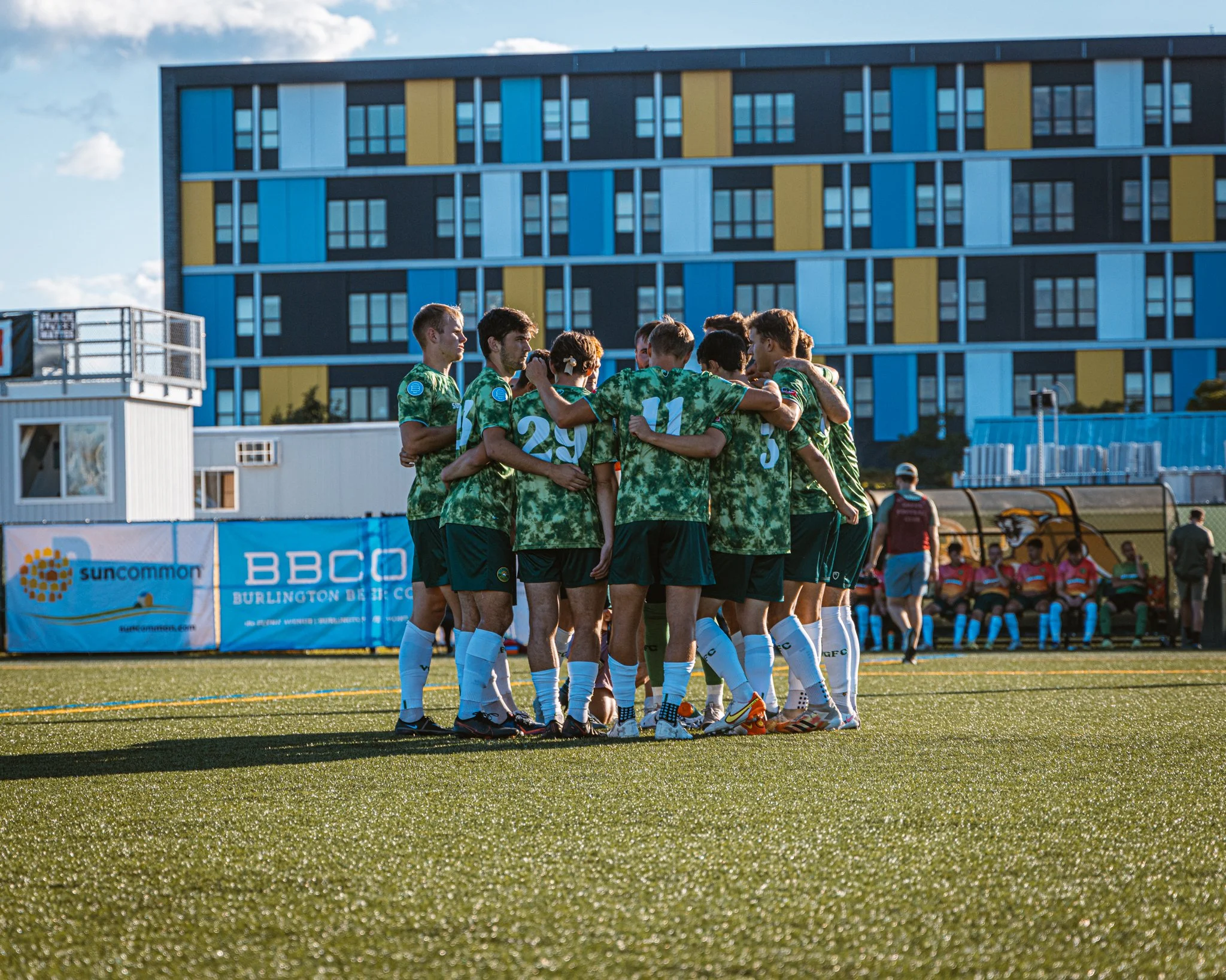 Vermont Green FC players in a matchday huddle, 2022.