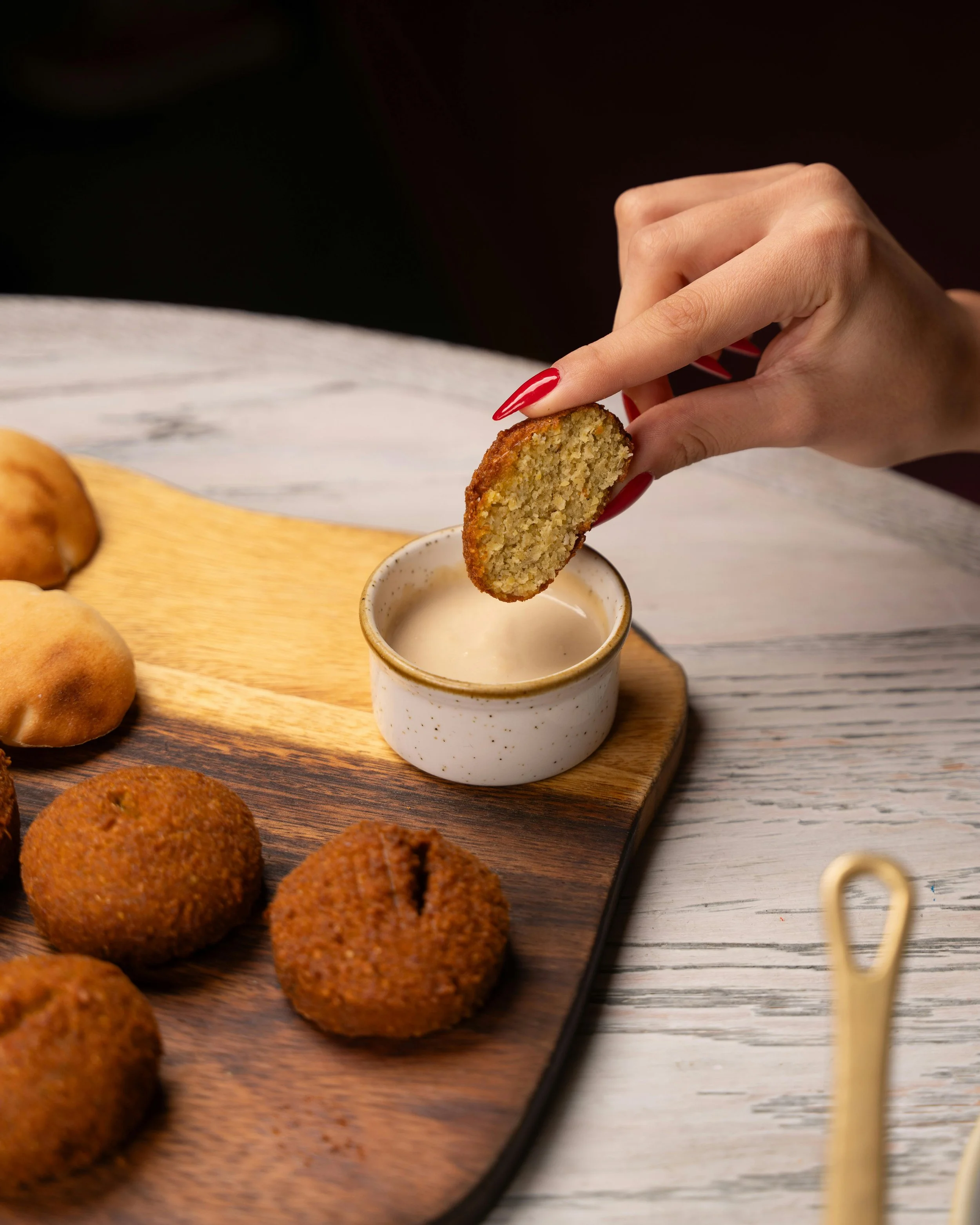 Kubbeh dipping — Lebanese kubbeh served with sauce