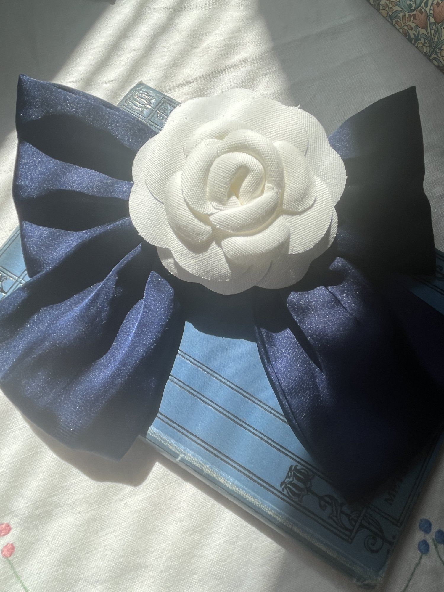 Chanel Camélia White Flower on black satin bow — The Year of Juniper