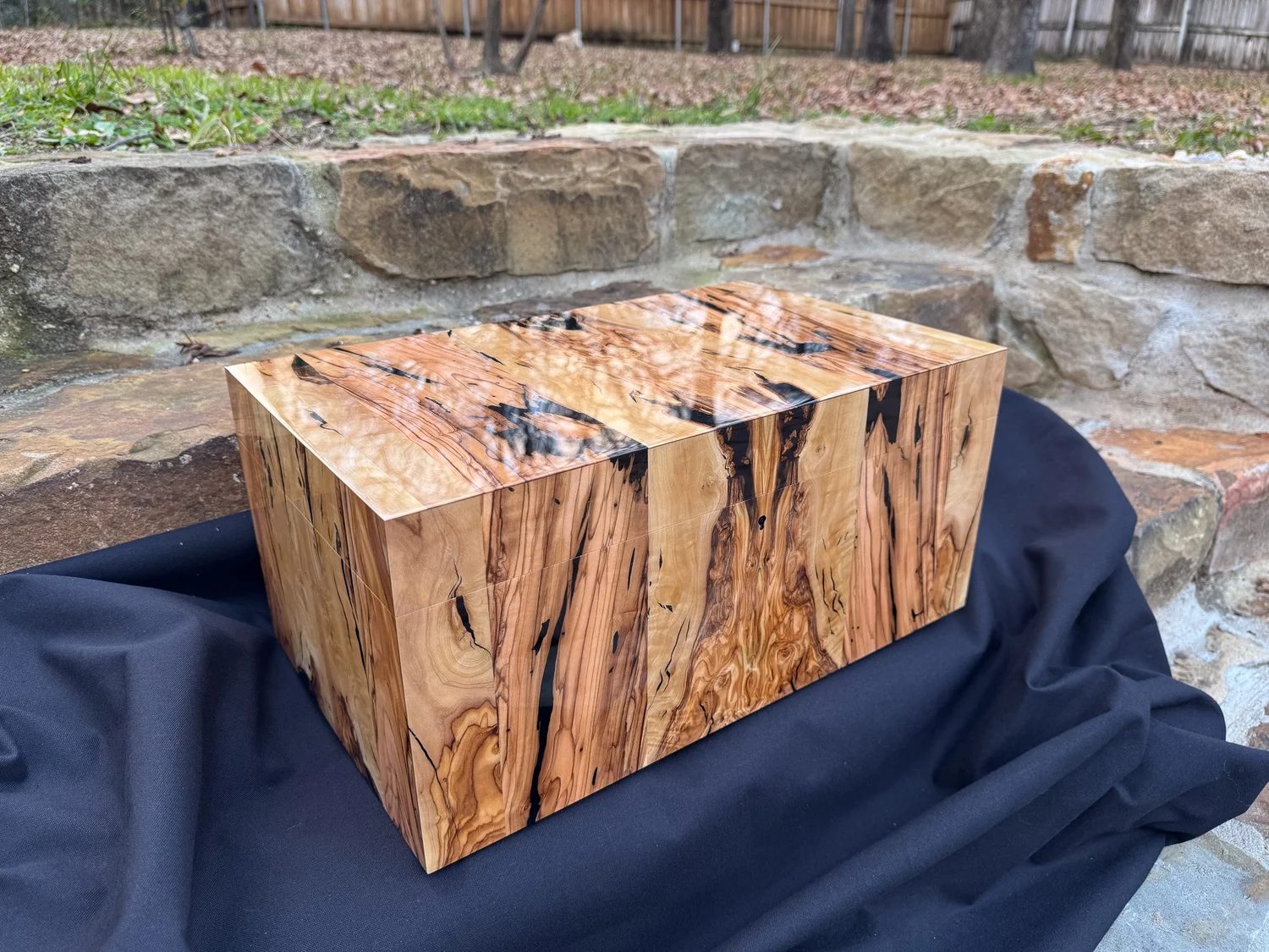 High‑gloss olivewood exterior under natural light