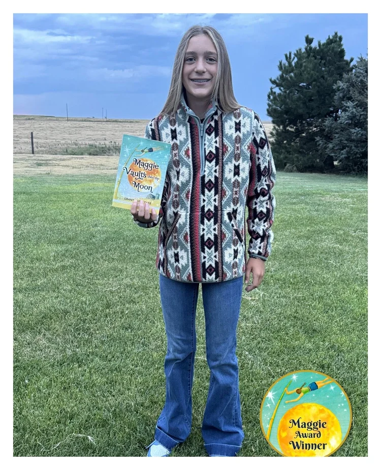 Maggie Award winner holding her book, with the Maggie Award Winner seal