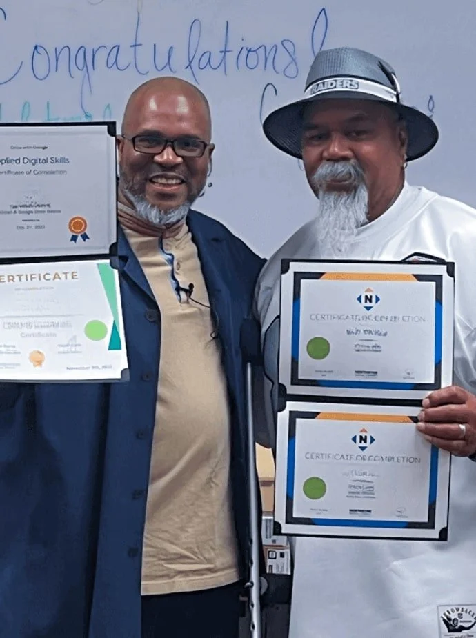teacher and student looking at camera holding up certificates