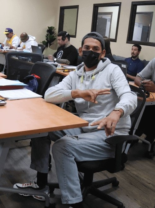 student with face mask in classroom 
                    