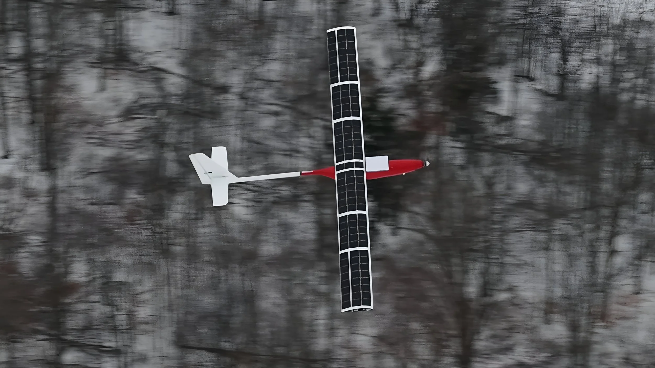 SW-117 flying over winter terrain