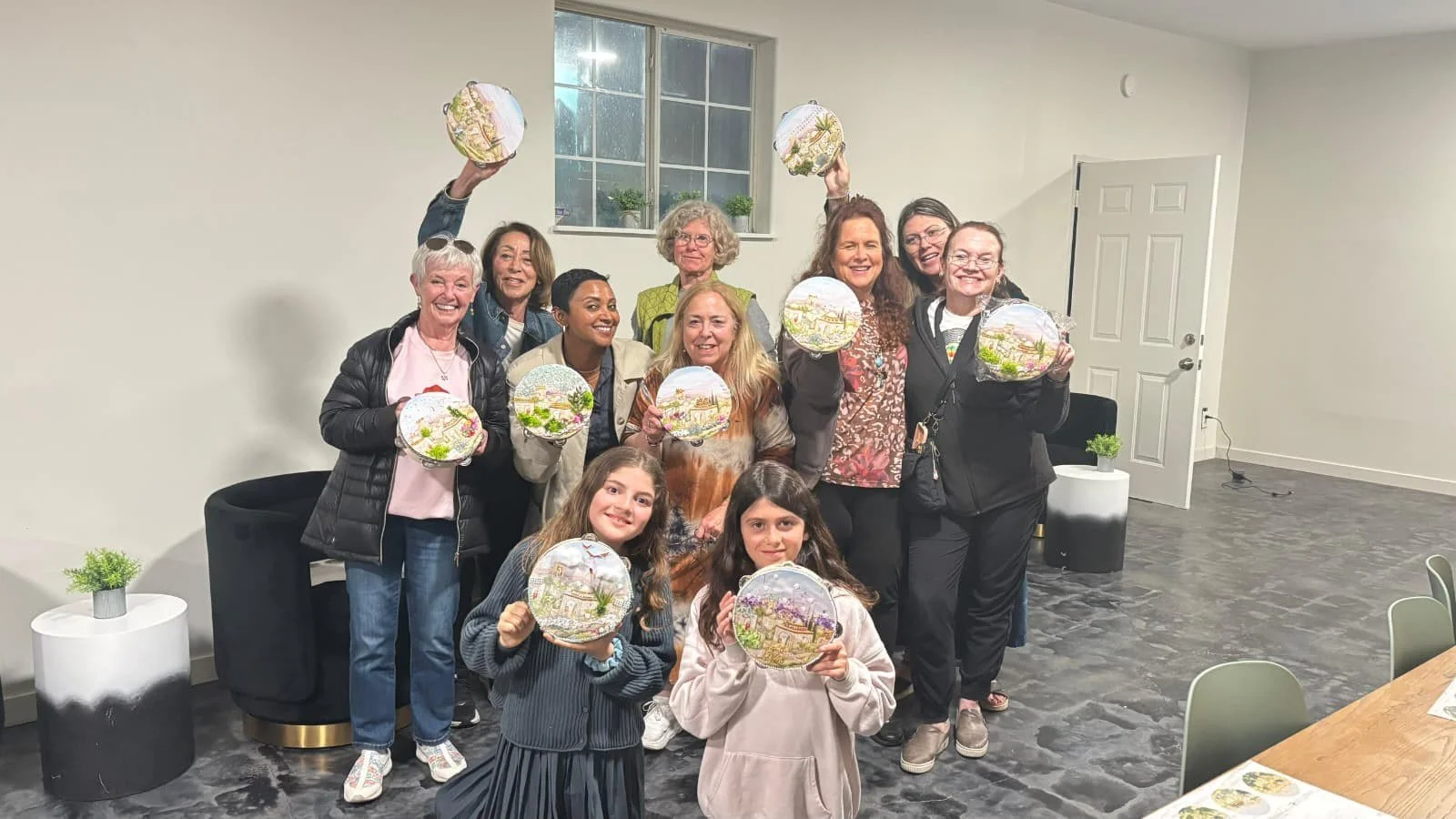 Women's class holding their craft projects