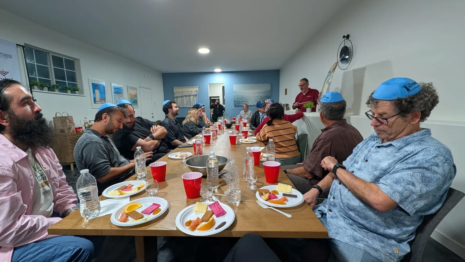 Friends around the Shabbat table at the Lighthouse