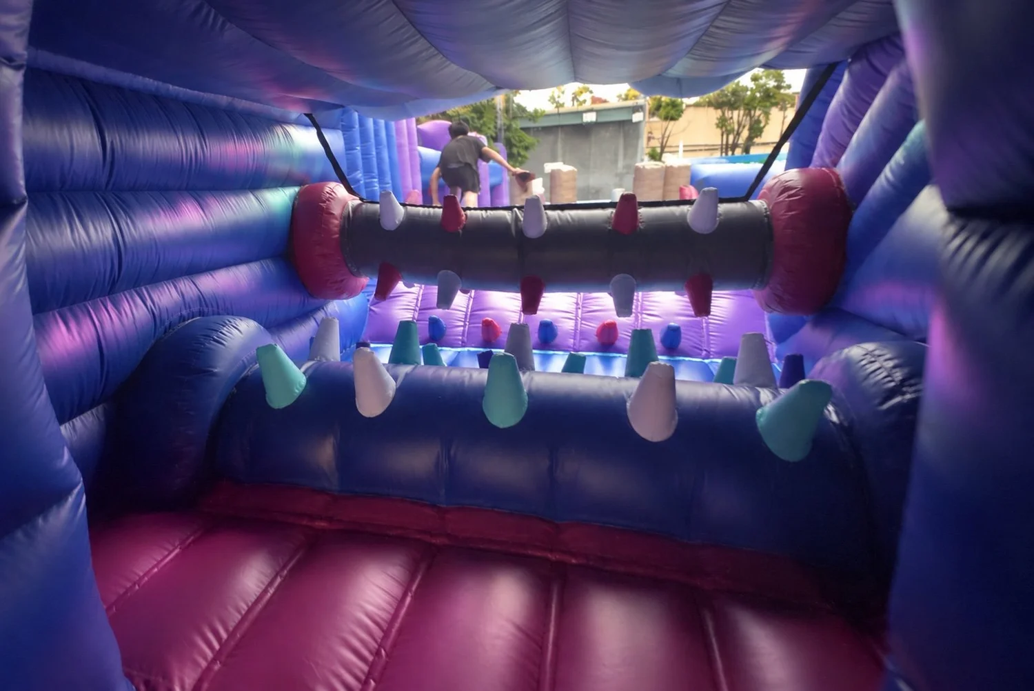 Interior of the illuminated inflatable cave with colorful Yeti-horn obstacles