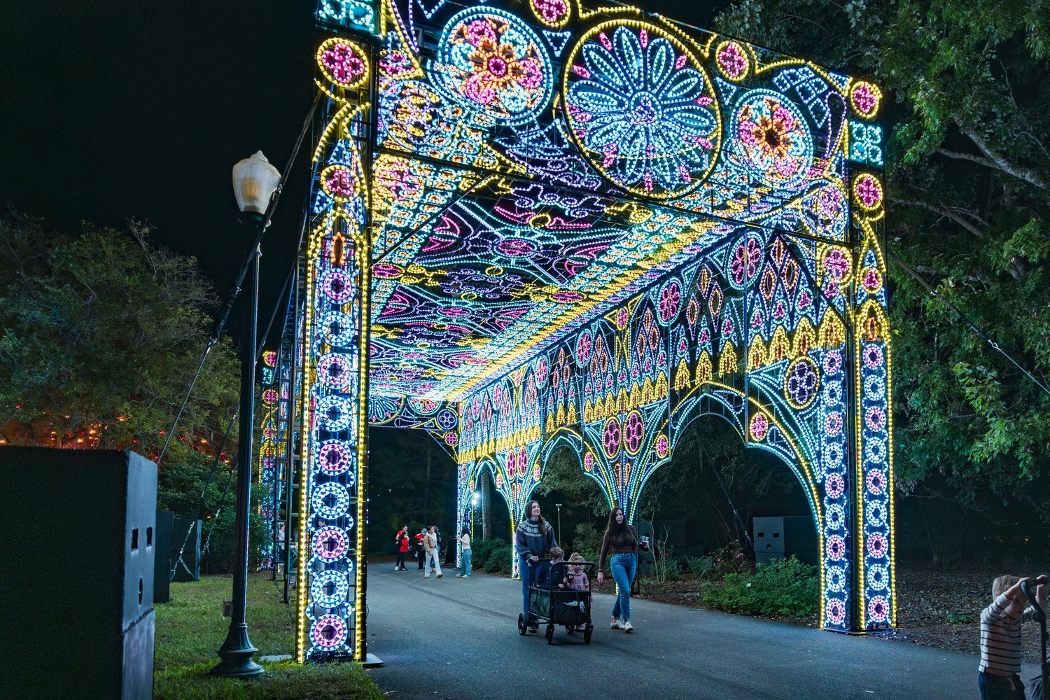 Guests walking through the illuminated stained-glass-inspired Cathedral at Dazzling Nights in 2025