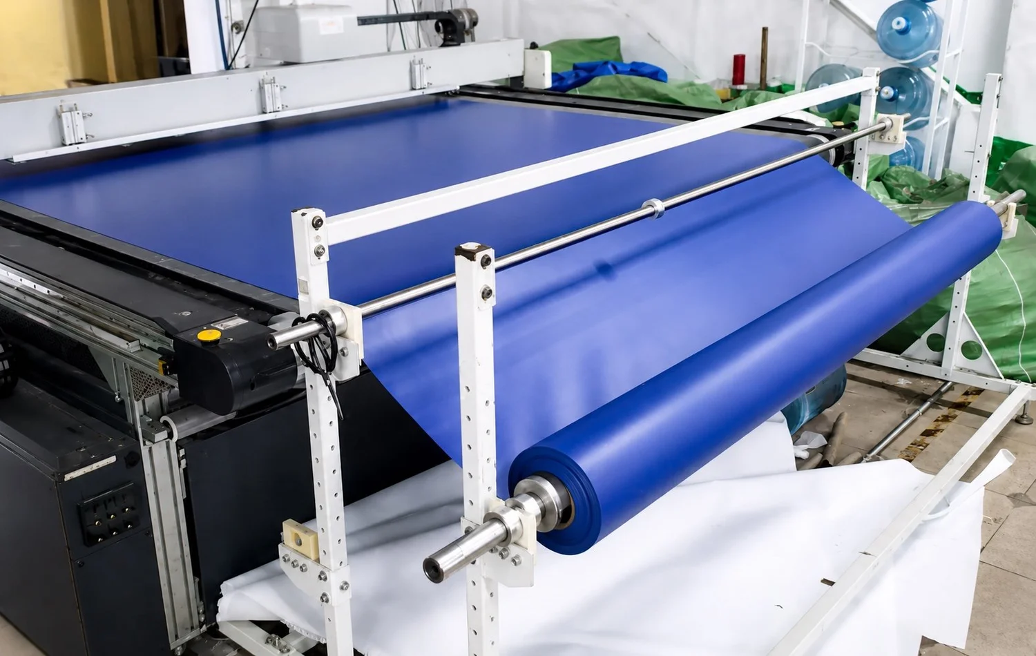 Large cutting table preparing the original blue inflatable material in the workshop