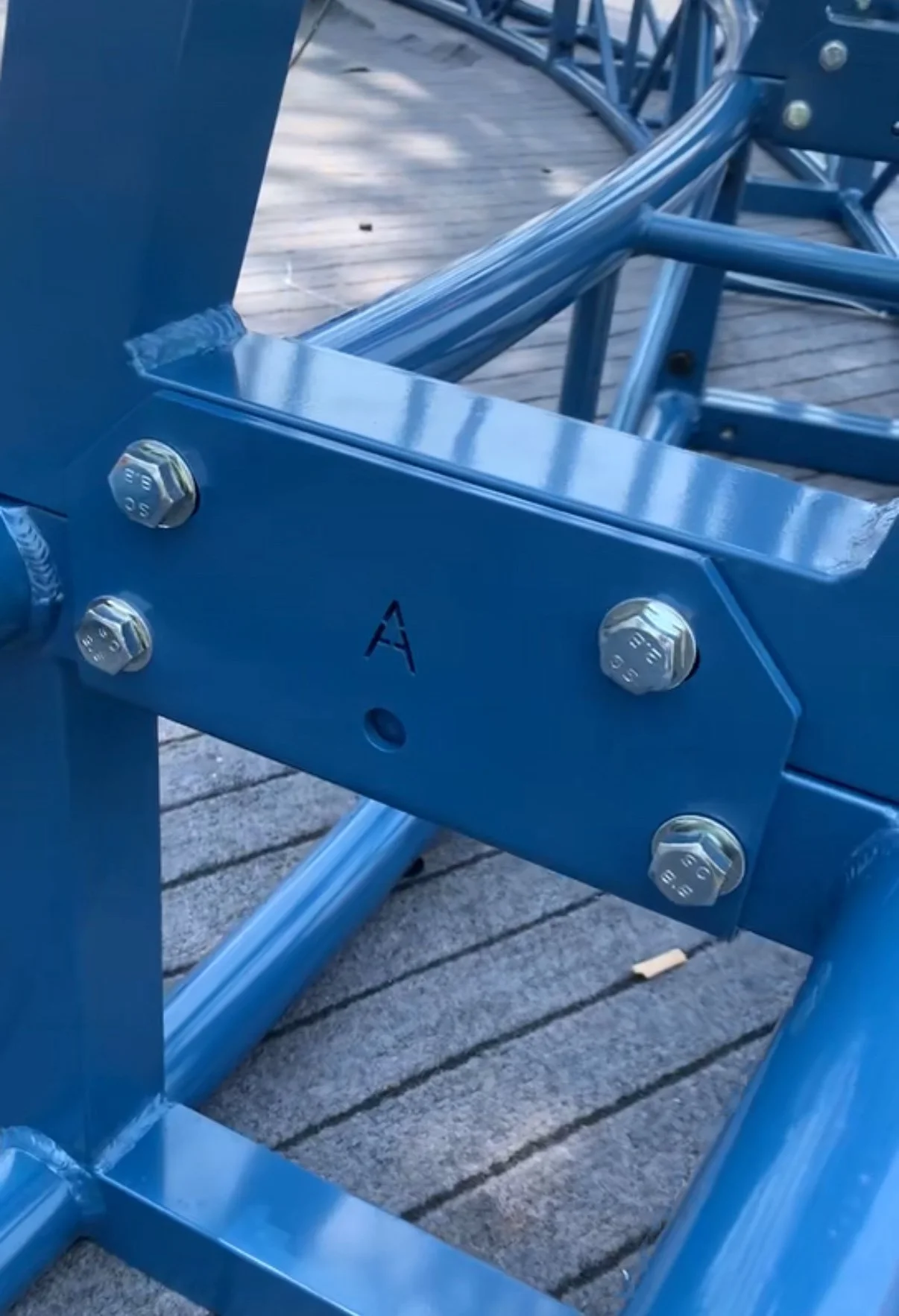 Close view of labeled blue metal connections used to guide snowman assembly