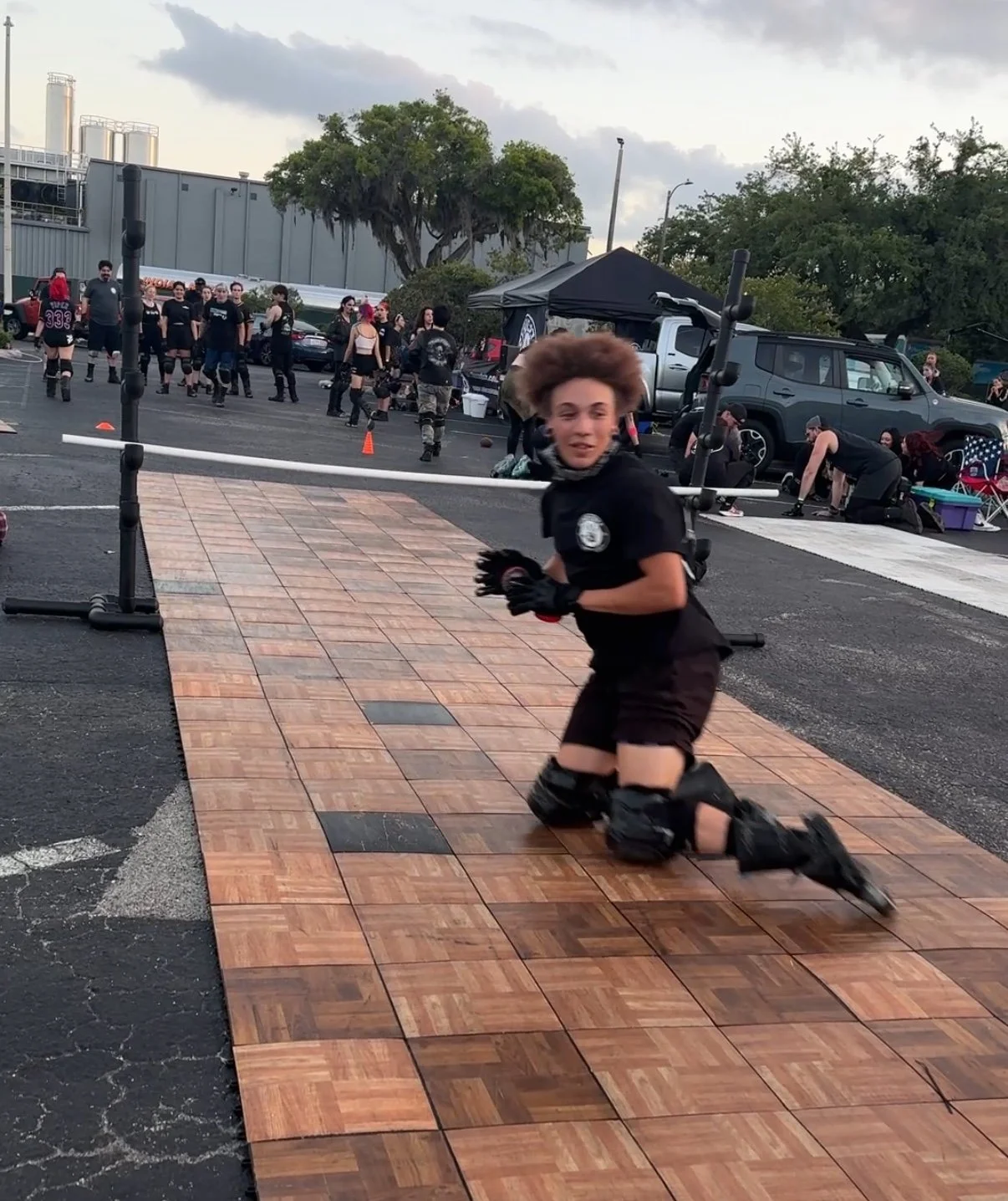 A slider turning rapidly across an outdoor performance floor