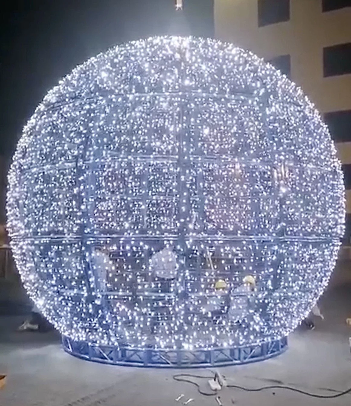 Fabricators standing inside the enormous illuminated head of the snowman