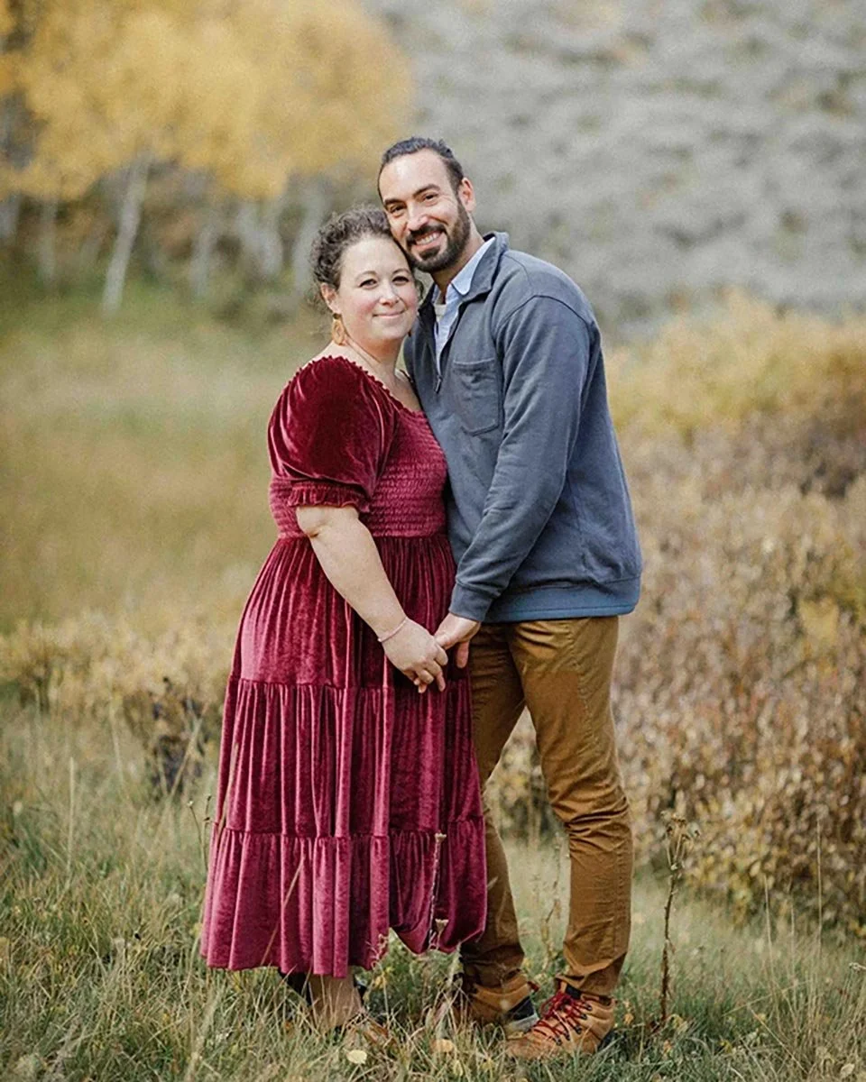 James and Katie Stokes, founders of Stokeshire, standing together outdoors in autumn grass.