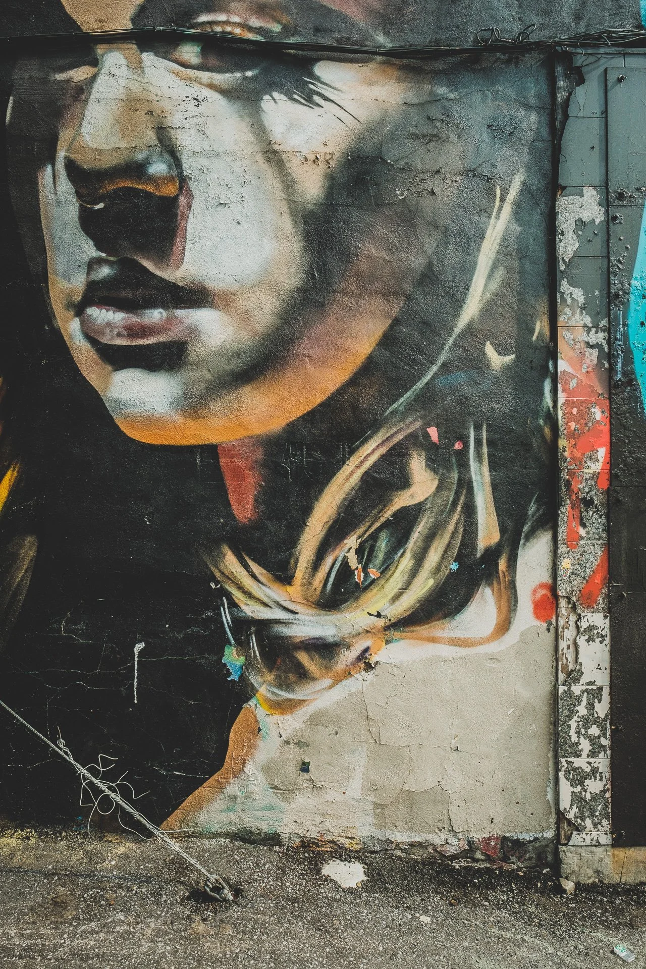 Montréal street photography — vertical shot of urban architecture and graffiti, Fujifilm