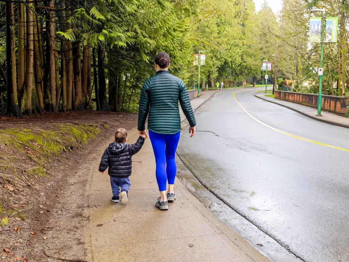 A parent and child walking to school on a Burnaby street
