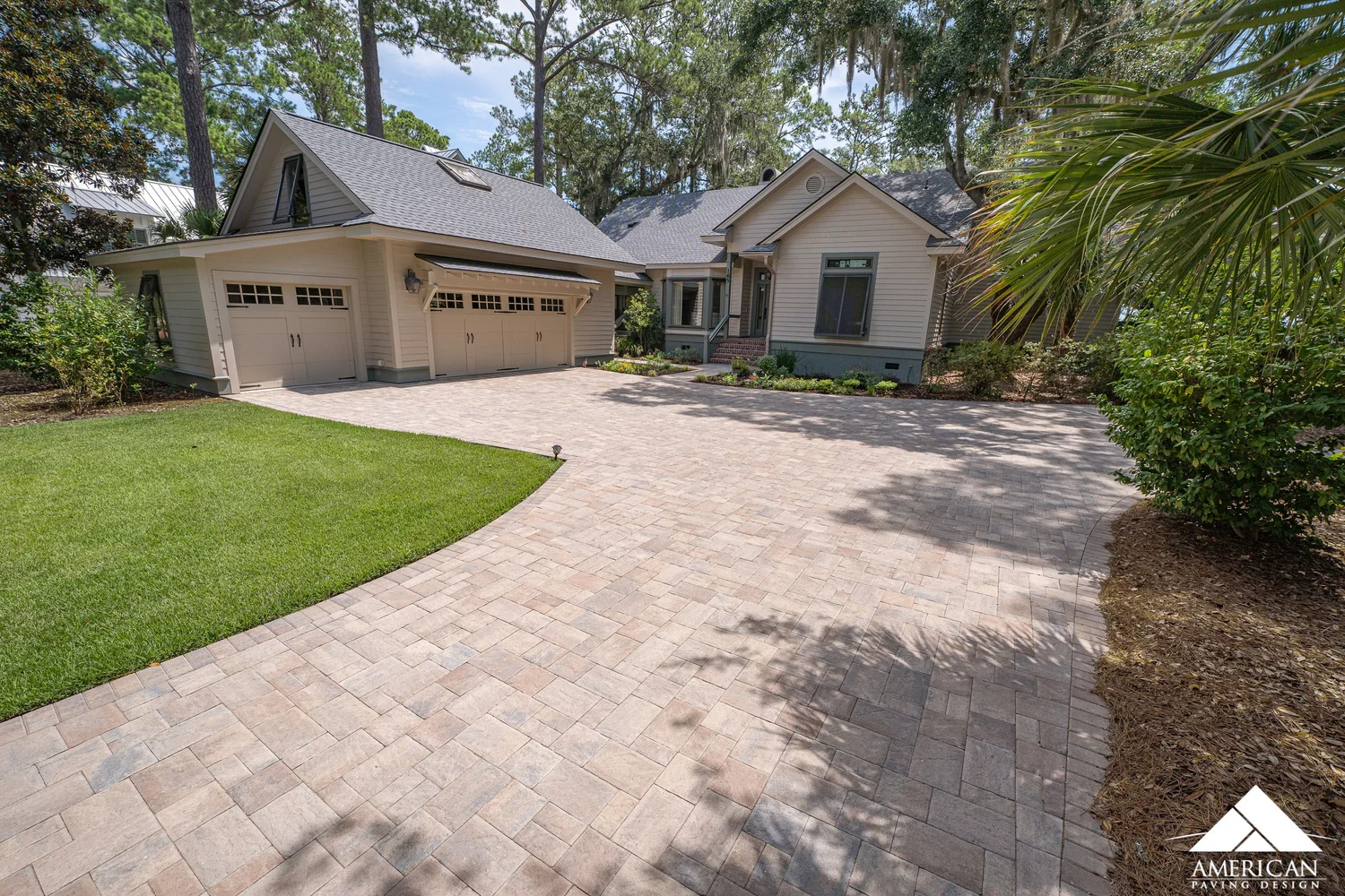 Curved paver driveway in a tan and gray blend at a Bluffton, SC home, installed by American Paving Design