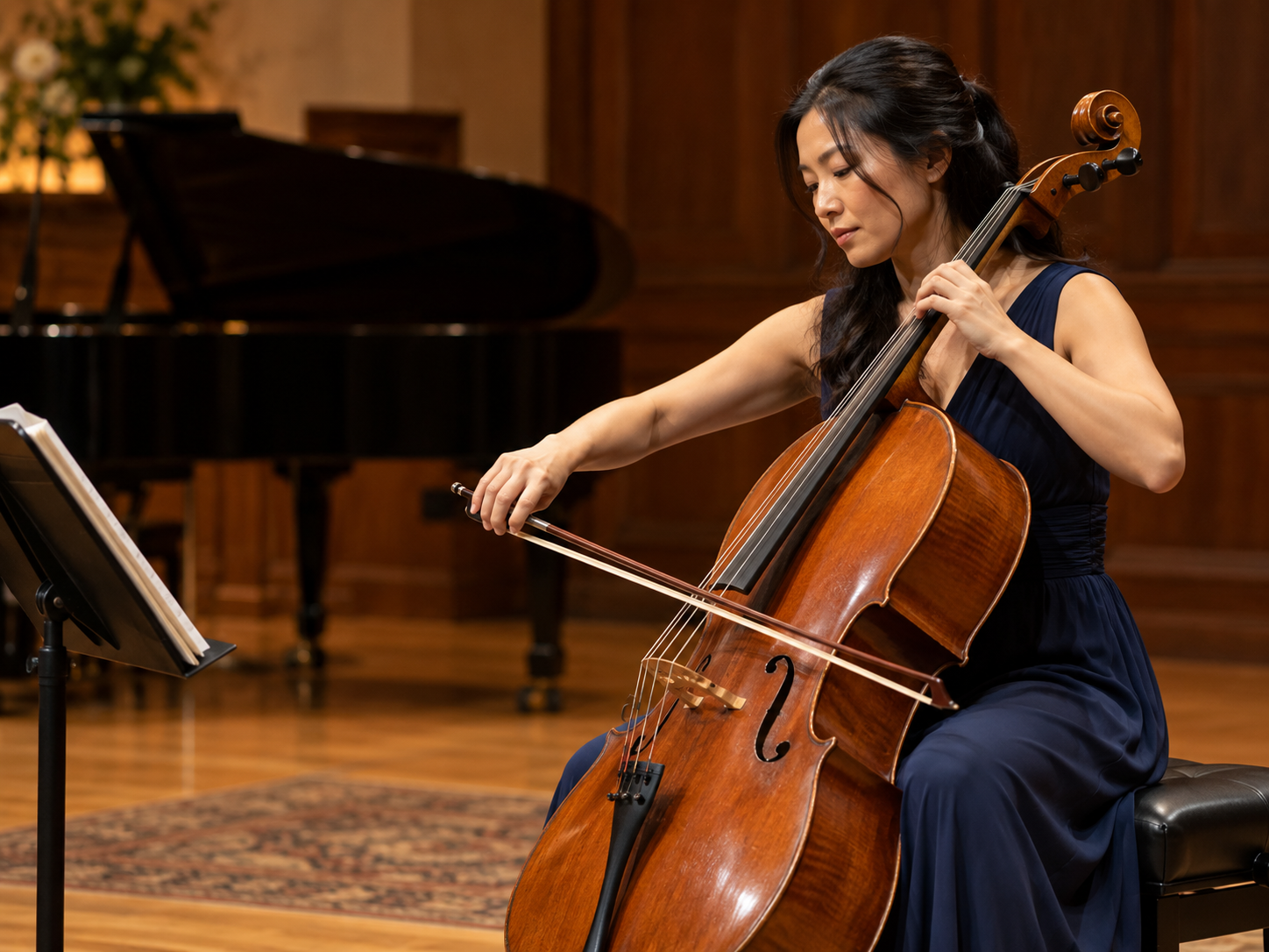 Illustrative scene of an adult cellist performing on a warmly lit stage