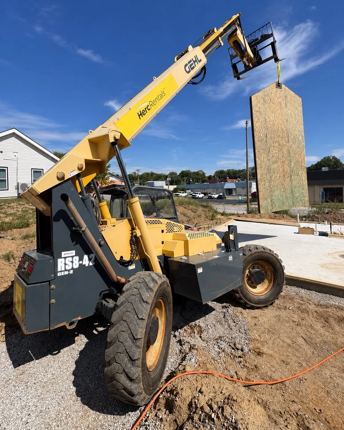 Prefabricated wall suspended over the home foundation
