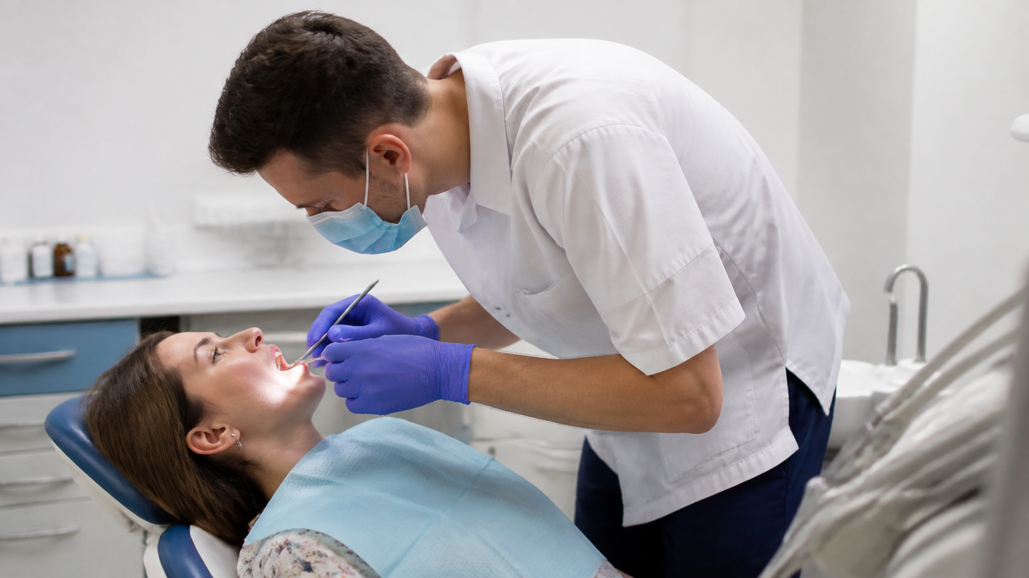 Dental professional bending over a patient — work posture and alignment for dentists and hygienists, Symmetry for Health