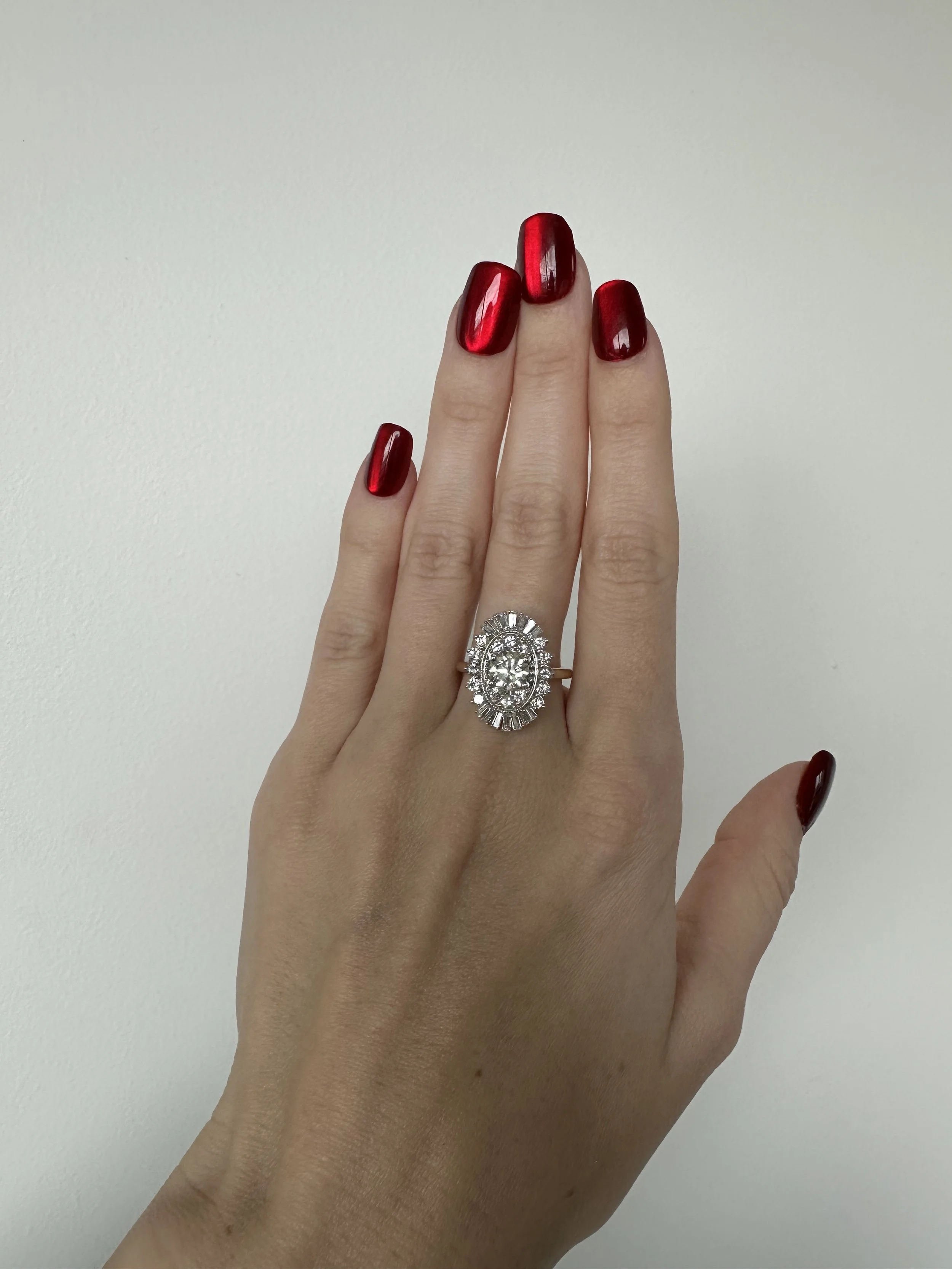 Finished heirloom ballerina halo engagement ring on hand, redesigned from inherited family diamonds by A. D'Mae Diamonds Los Angeles