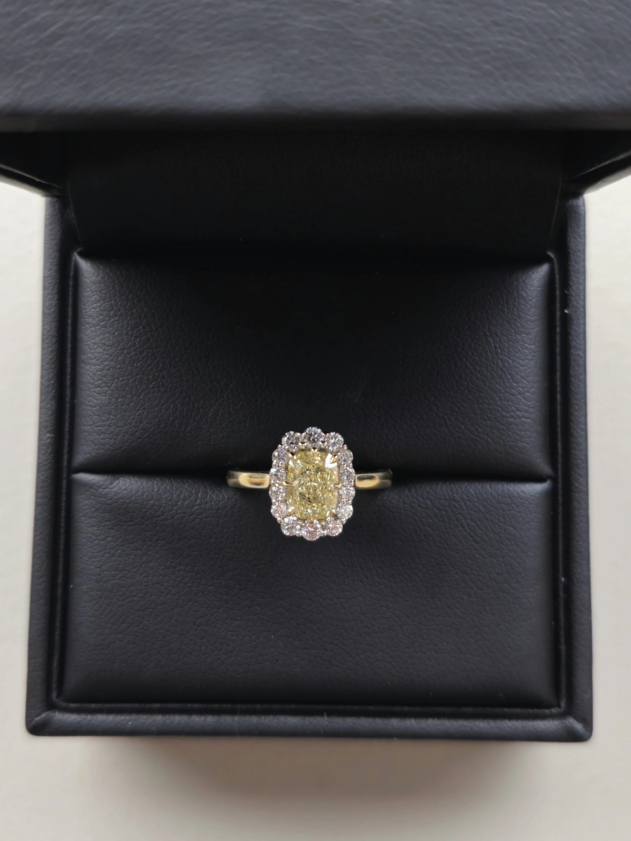 Bespoke yellow diamond engagement ring with diamond halo setting in 18k gold by A. D'Mae Diamonds Los Angeles