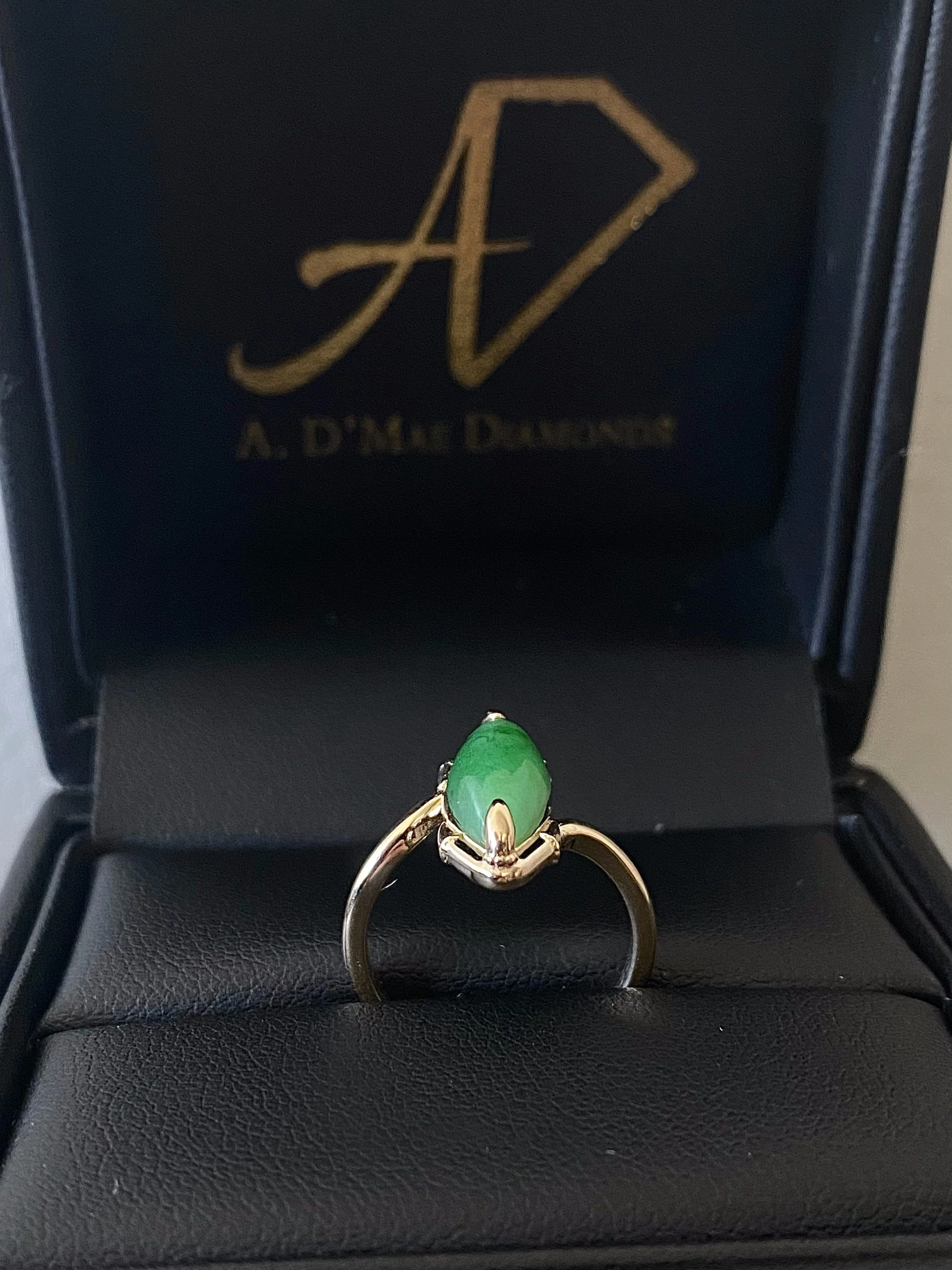 Finished custom jade raven claw engagement ring in A. D'Mae Diamonds presentation box, Los Angeles