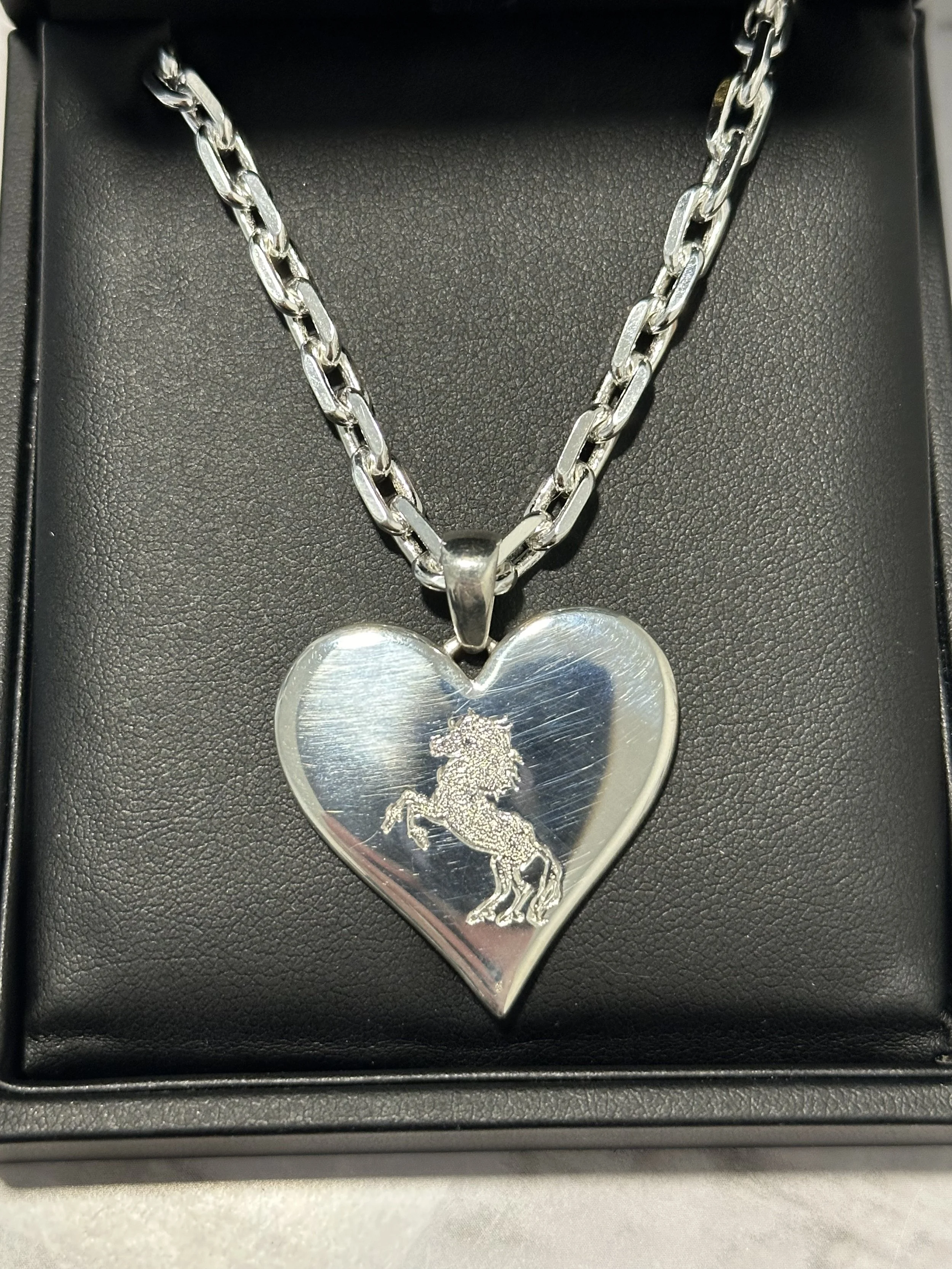 Close-up detail of custom three-dimensional heart necklace for rock musician, cast in precious metal, designed by A. D'Mae Diamonds Los Angeles
