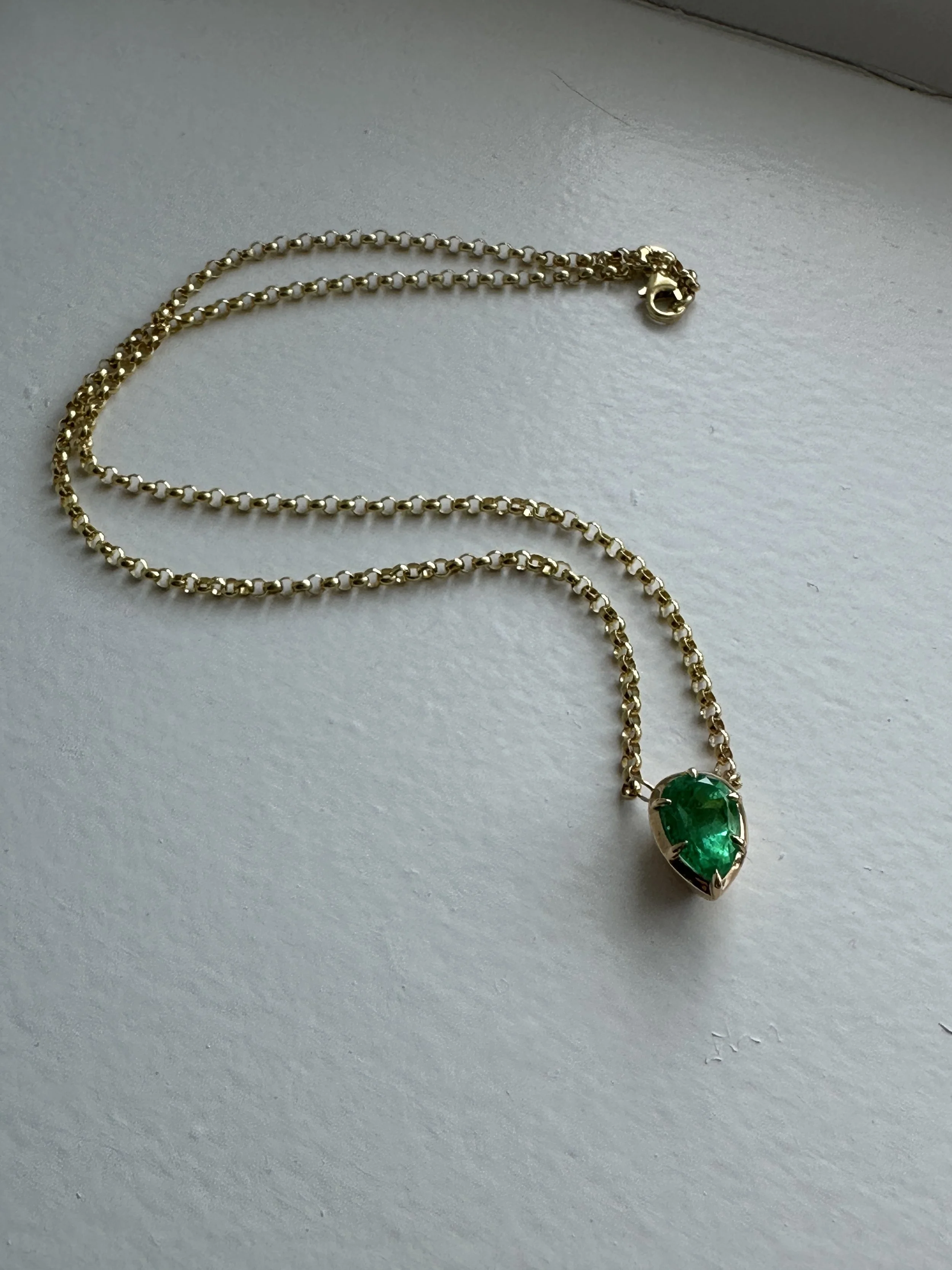 Finished custom Colombian emerald necklace with 18k yellow gold Victorian-style chain and claw prong setting, designed by A. D'Mae Diamonds Los Angeles
