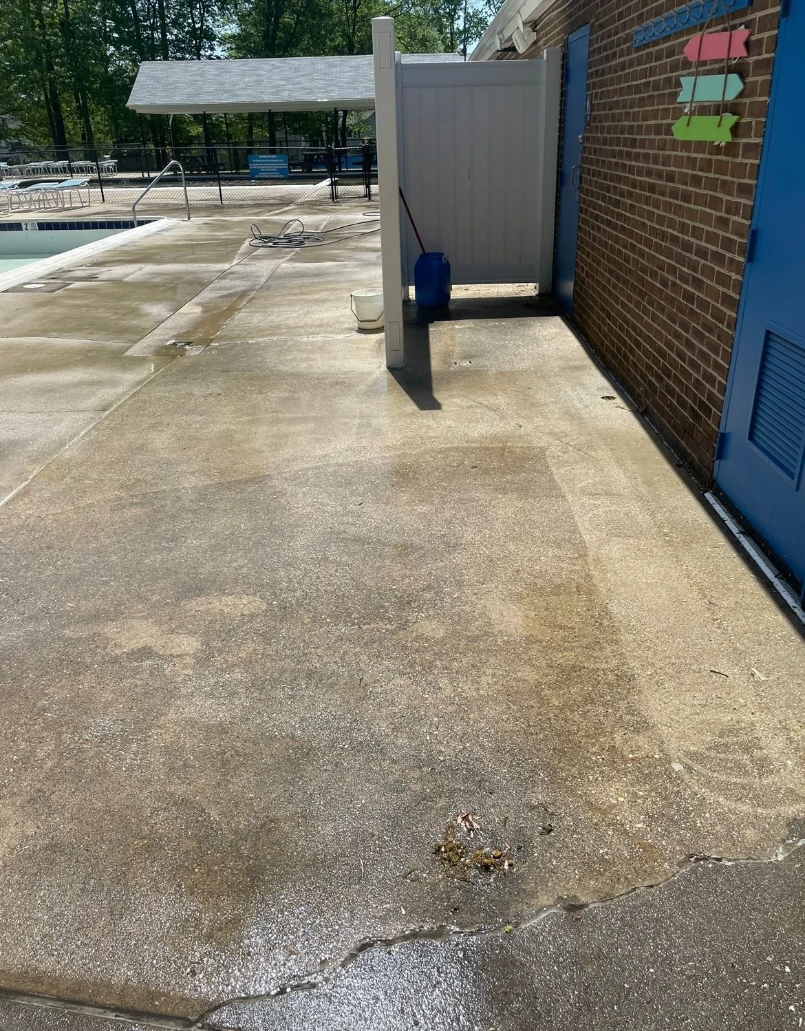 Concrete cleaning before Maryland stained patio pool surround