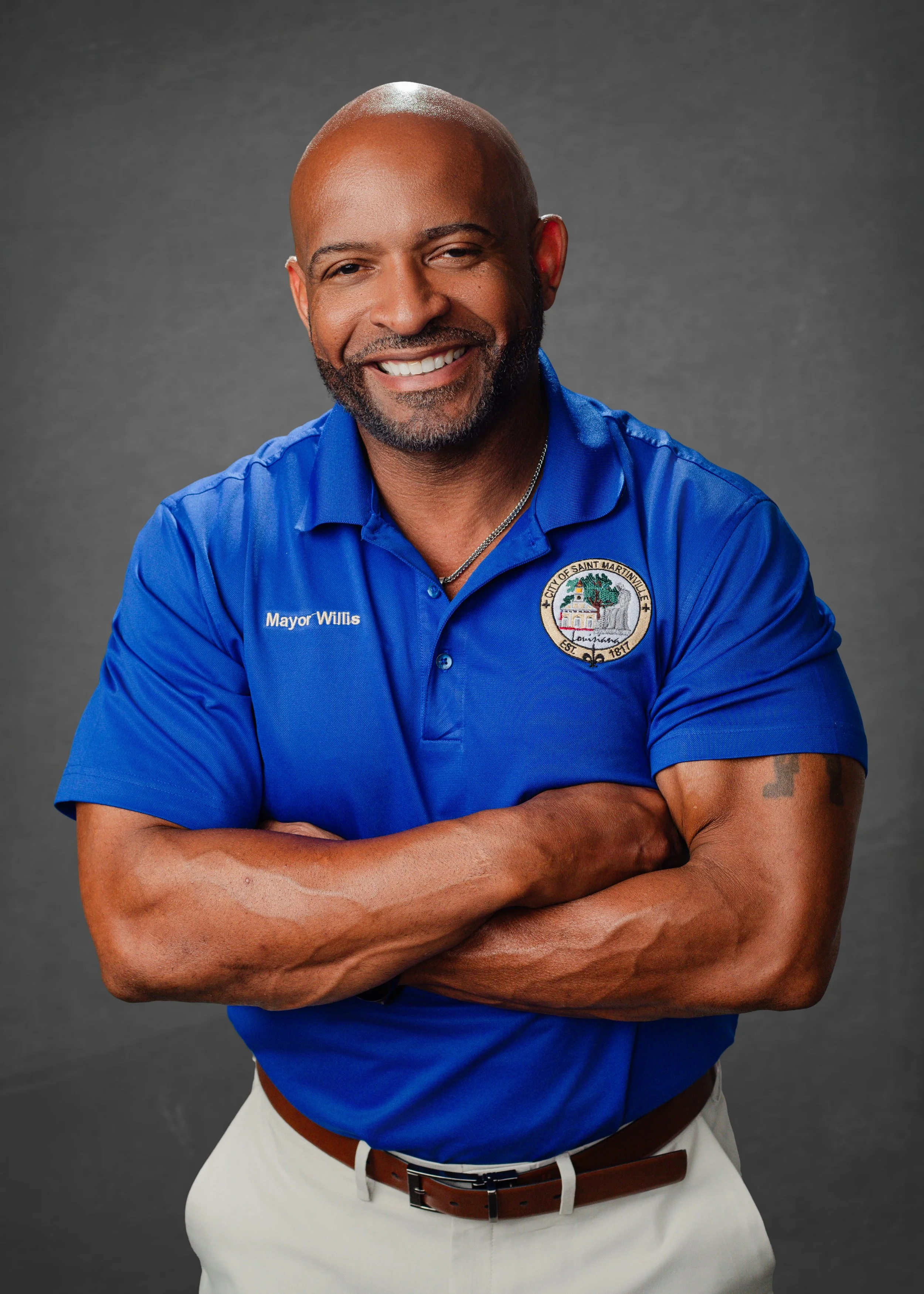 Headshot of Mayor Willis in front of a grey background wearing a blue polo style shirt.
