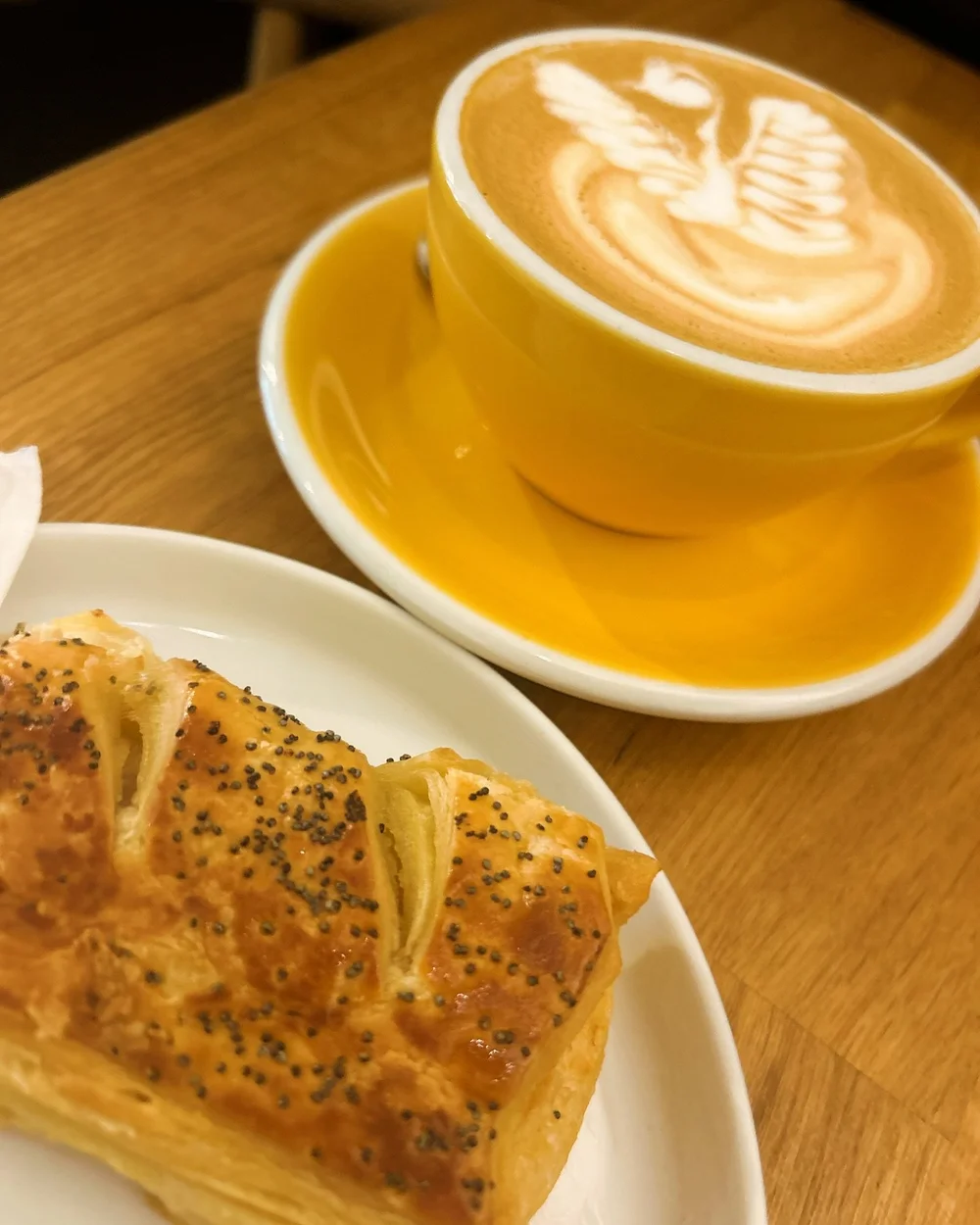 A sausage roll and flat white at Milligram