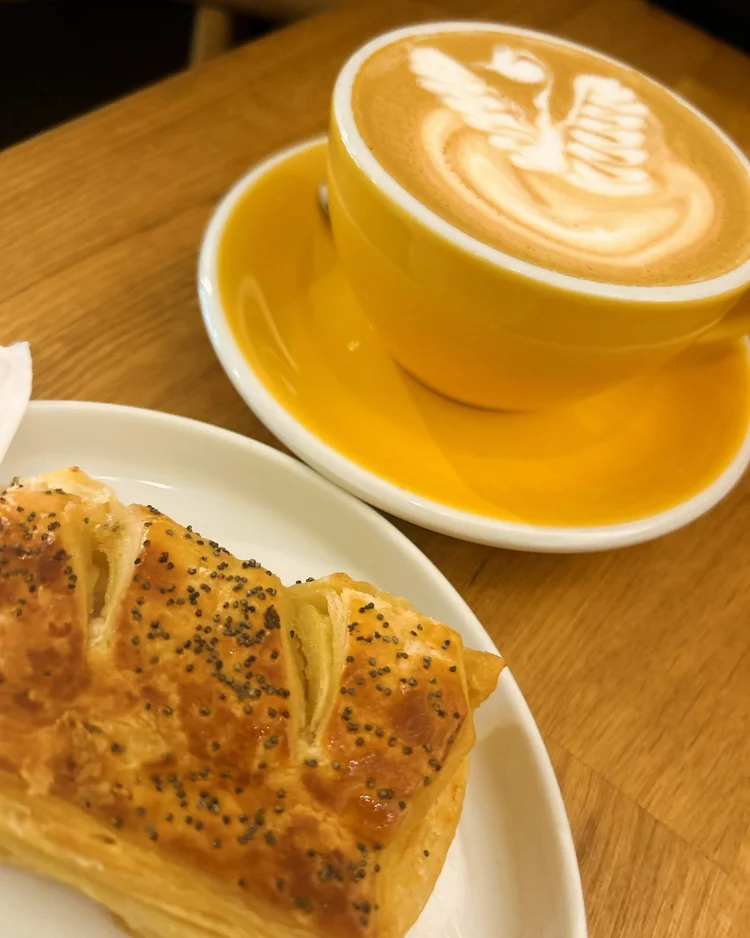 Flat white and sausage roll at Milligram