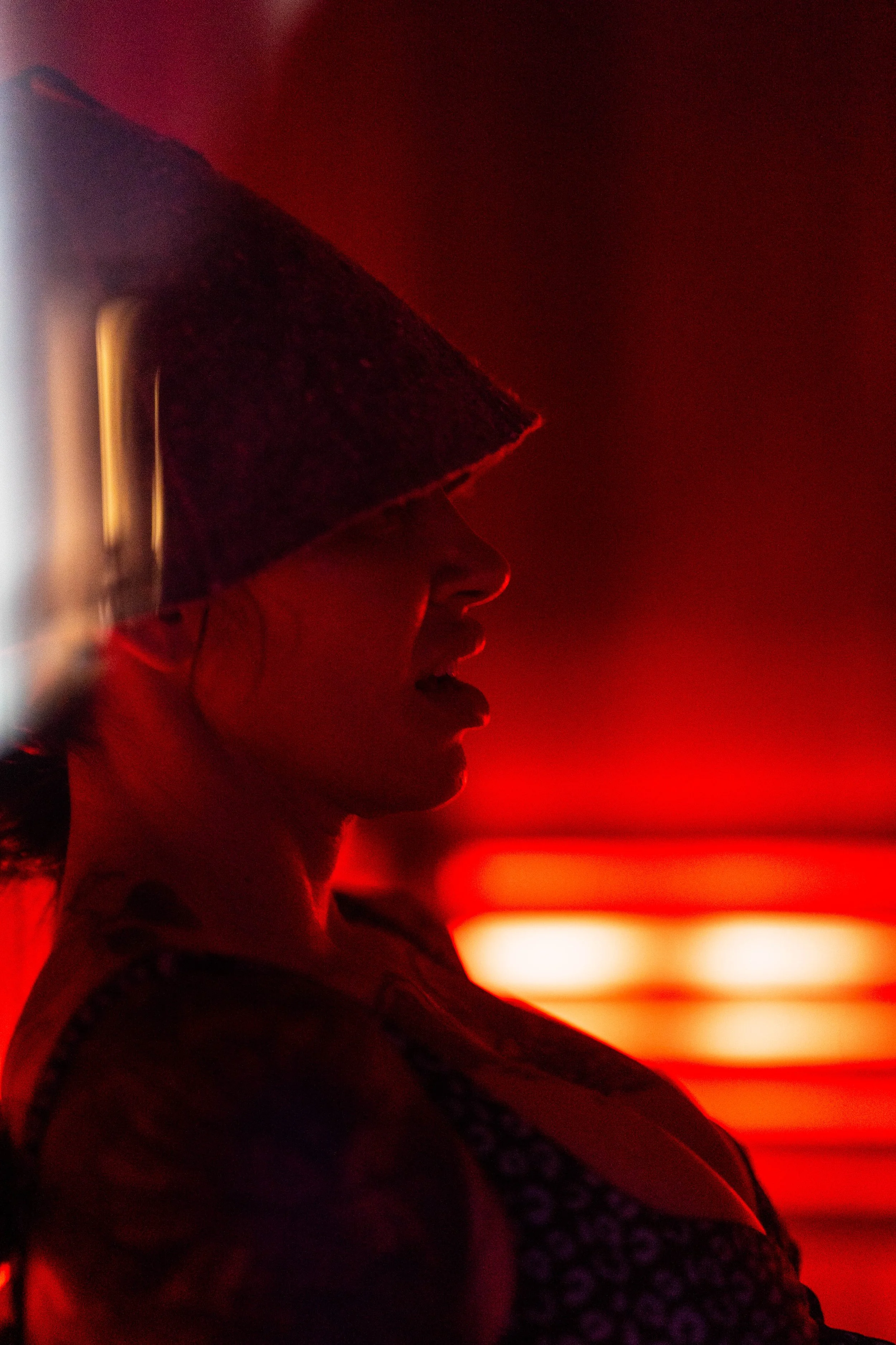 A guest seated in the infrared sauna under warm red light