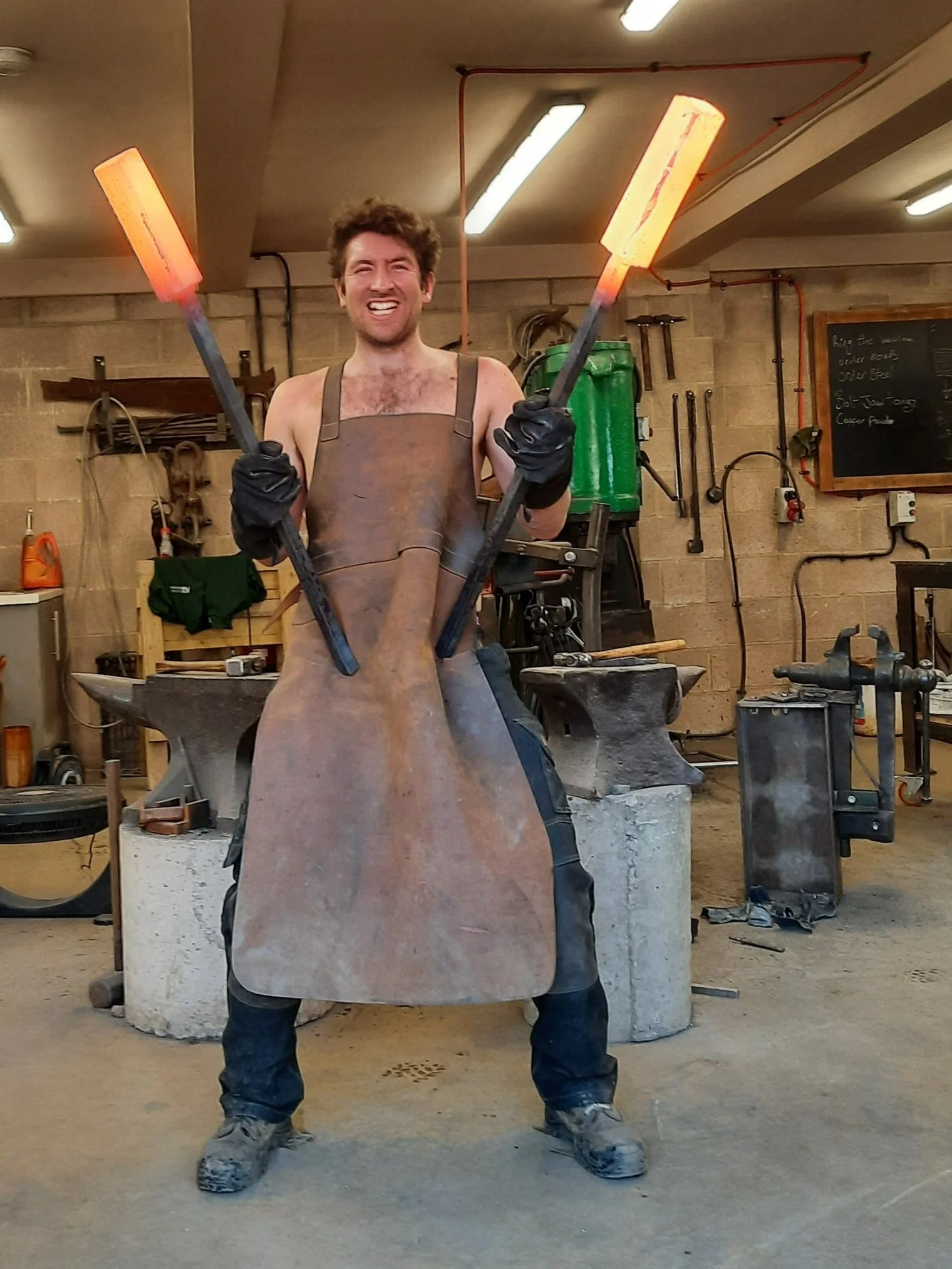 Ben Bodman forging a blade at the workshop press in Wiltshire
