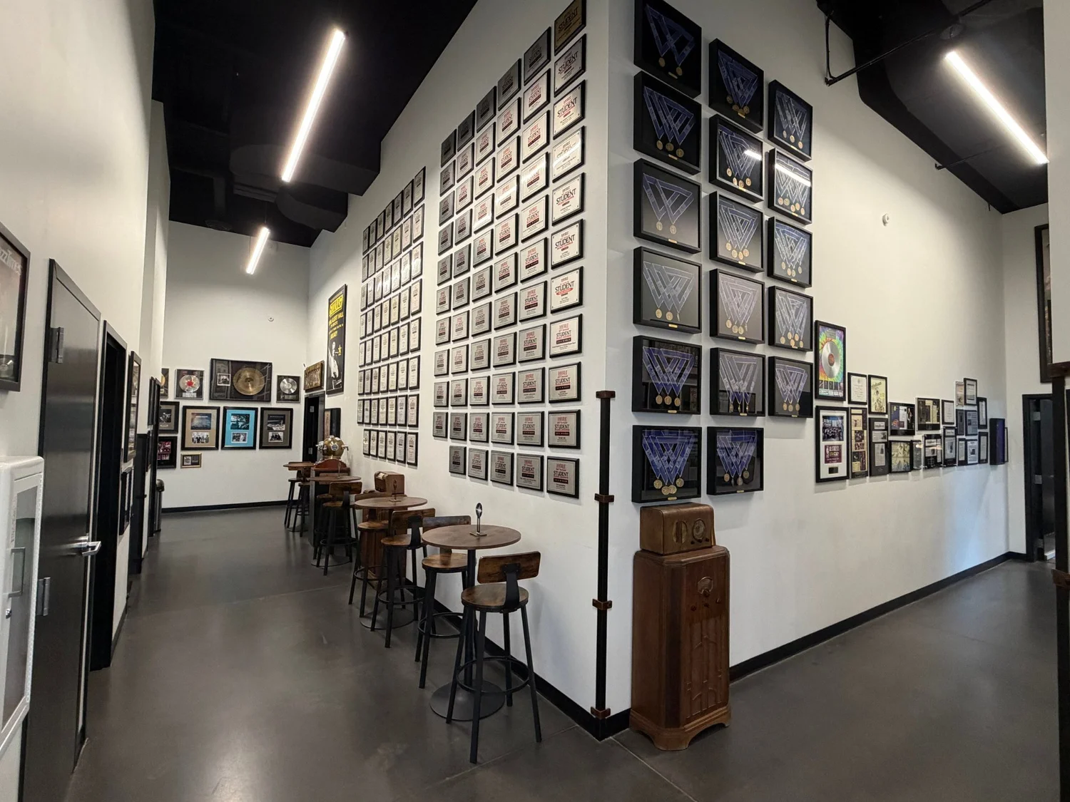 Corridor lined with DownBeat award plaques and Best of State medals