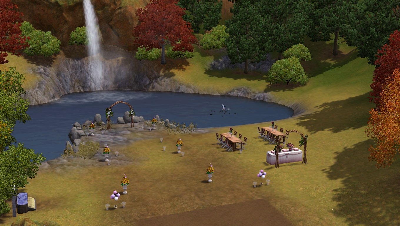A bird’s eye view of the Cinnamon Crest Falls lot in The Sims 3, decorated for a wedding. There is an area to the side with a buffet table, plus two tables with 6 chairs each. From the road, there are balloons, sunflower vases and candles flanking a wide path to an arch made of branches at the edge of the pond facing the waterfall.