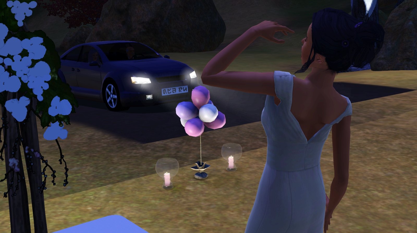 Dorothy Button’s back is visible in the foreground, one hand raised near her mouth as though she’s calling out (partial speech bubble visible). She is facing a dark car with its headlights on; her parents are visible in the front seats. At the edge of the lot there is a bundle of pink and white balloons flanked by two candles in glass vases.