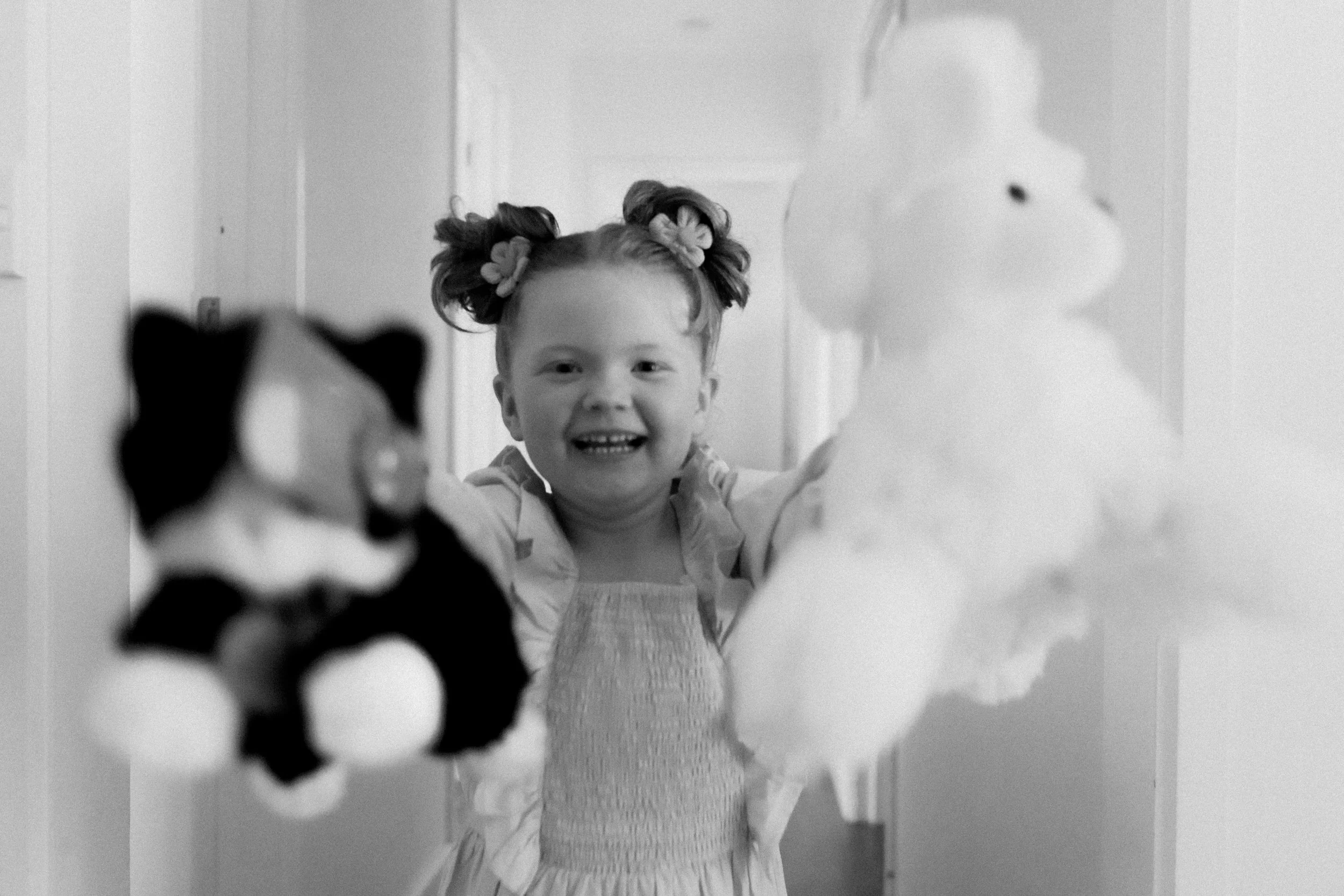 Black and white — kid dancing at the reception, full of energy
