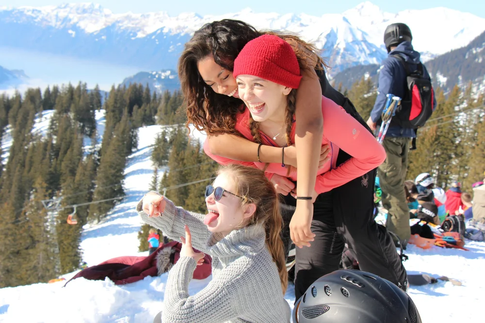 Ecole students laughing together in the snow