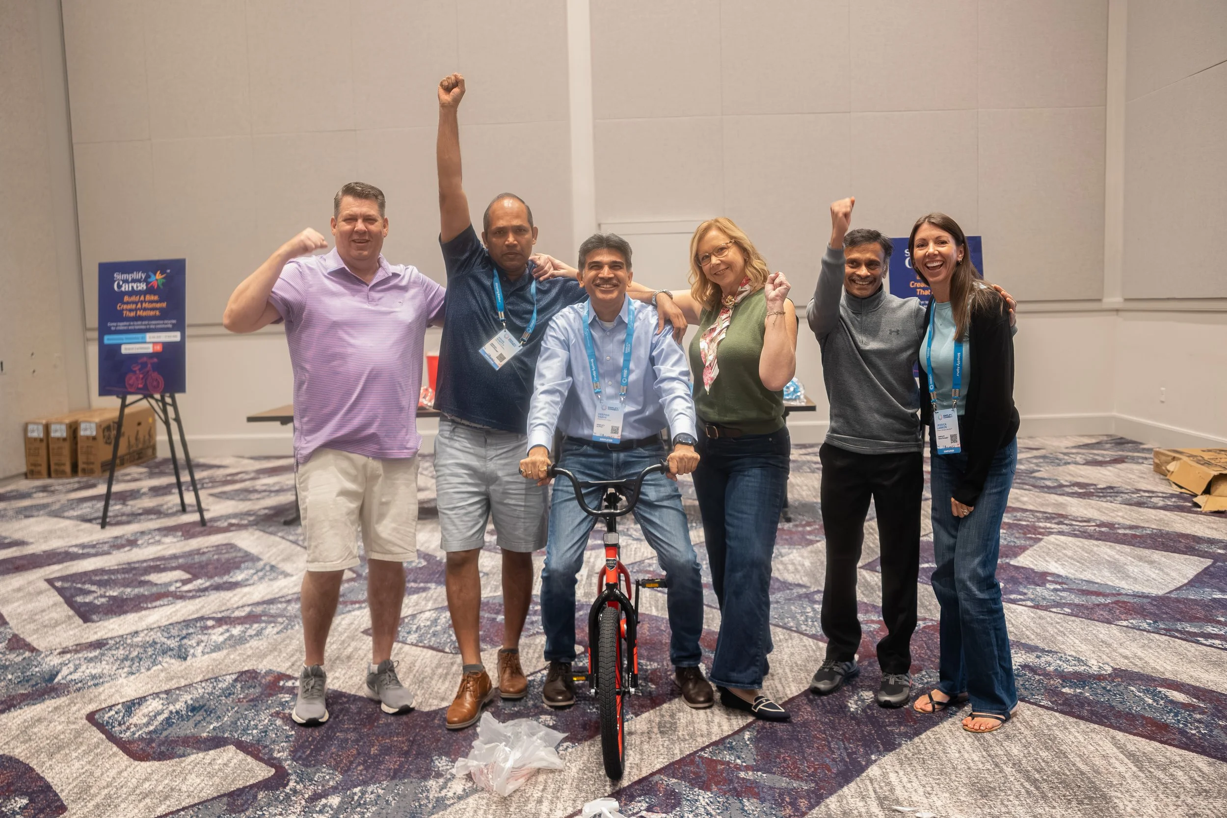 A team celebrates together during the Build-A-Bike charity event.