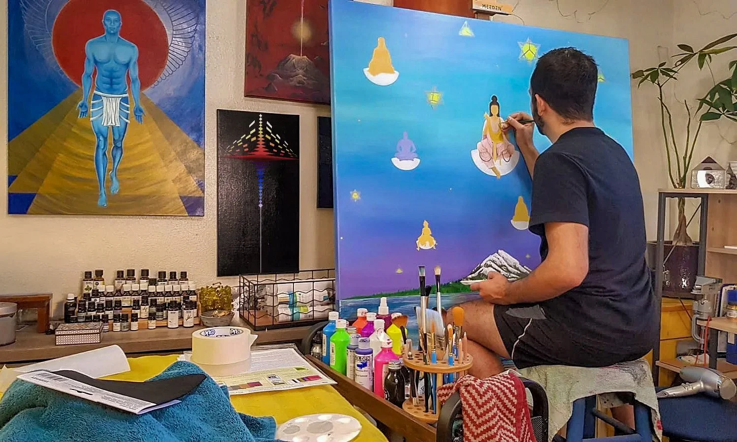 Navaji David Nava painting in his Austin home studio while developing his Light Works practice