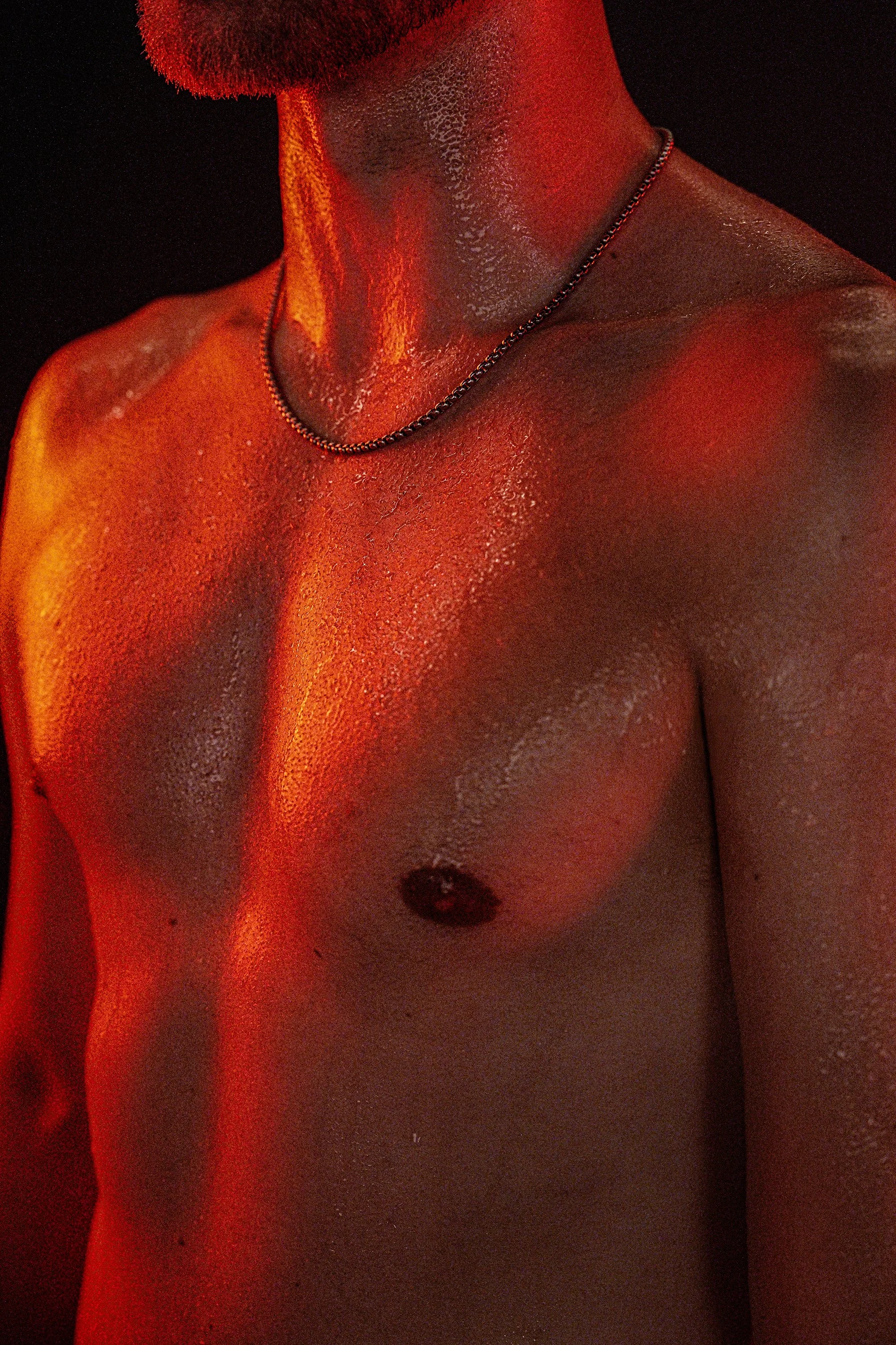 The Burn Room campaign photograph by Navaji David Nava showing torso and neck under sculptural red light