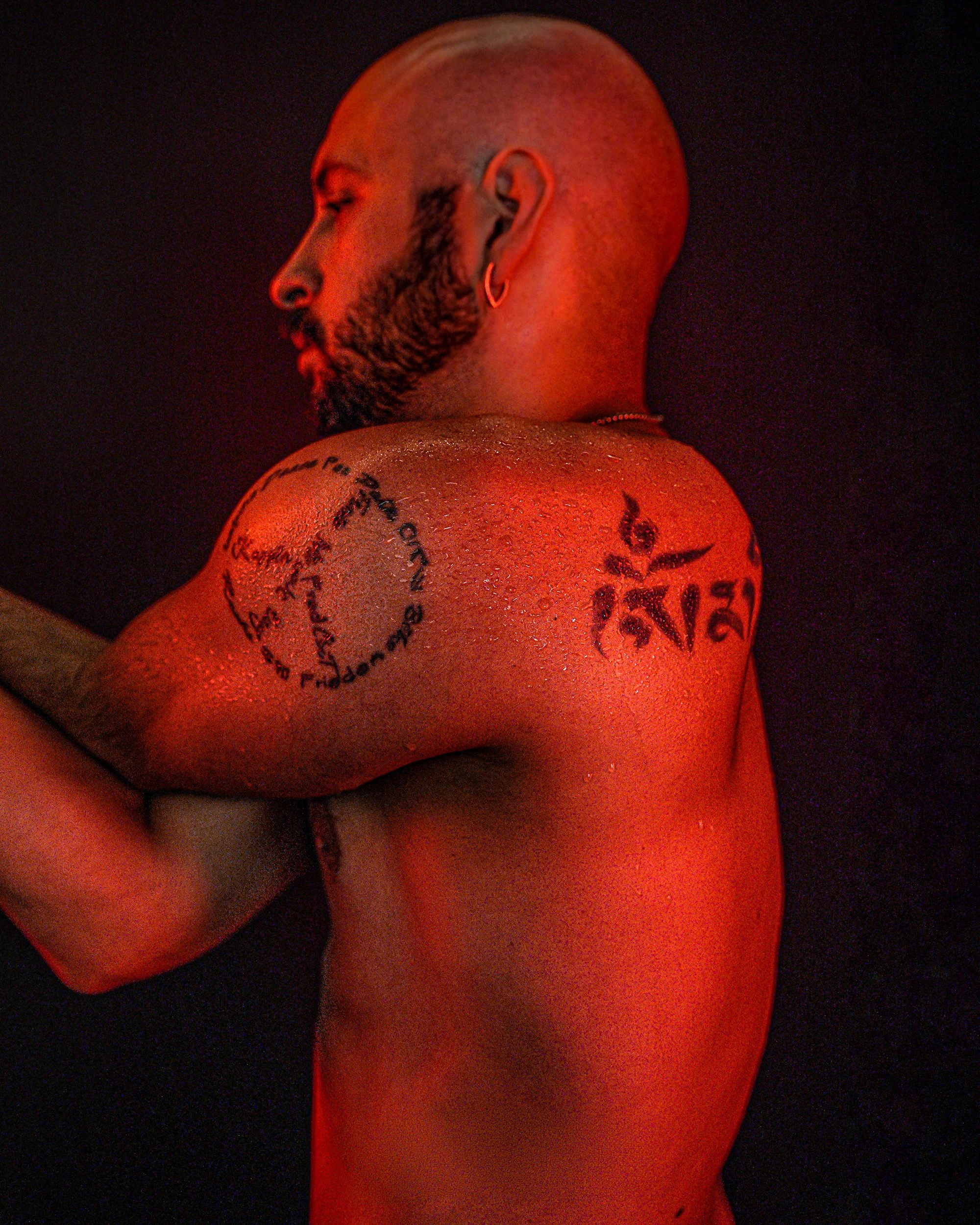 The Burn Room campaign photograph by Navaji David Nava showing a tattooed dancer in red studio light