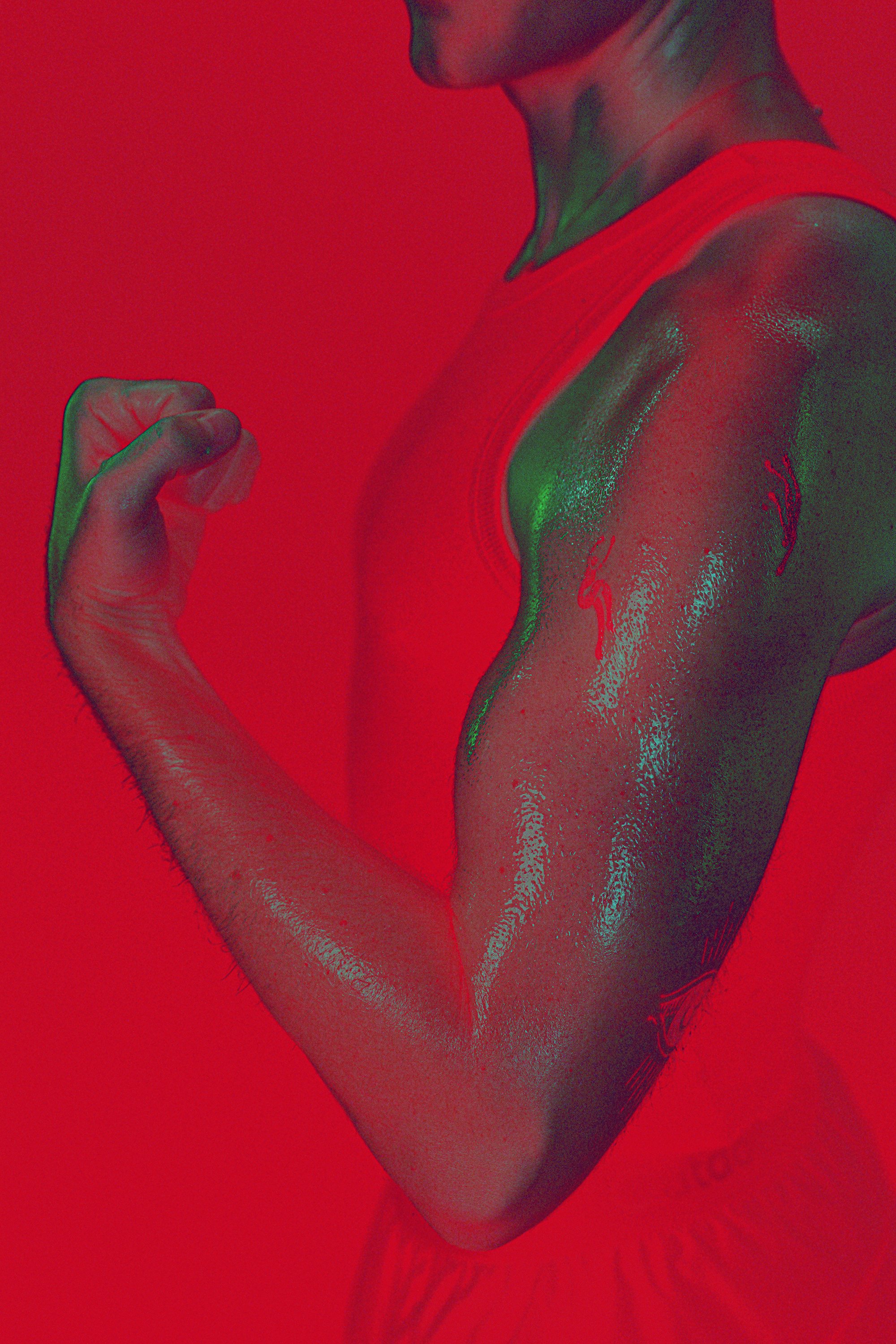 The Burn Room campaign photograph by Navaji David Nava showing an athletic arm under red and green light