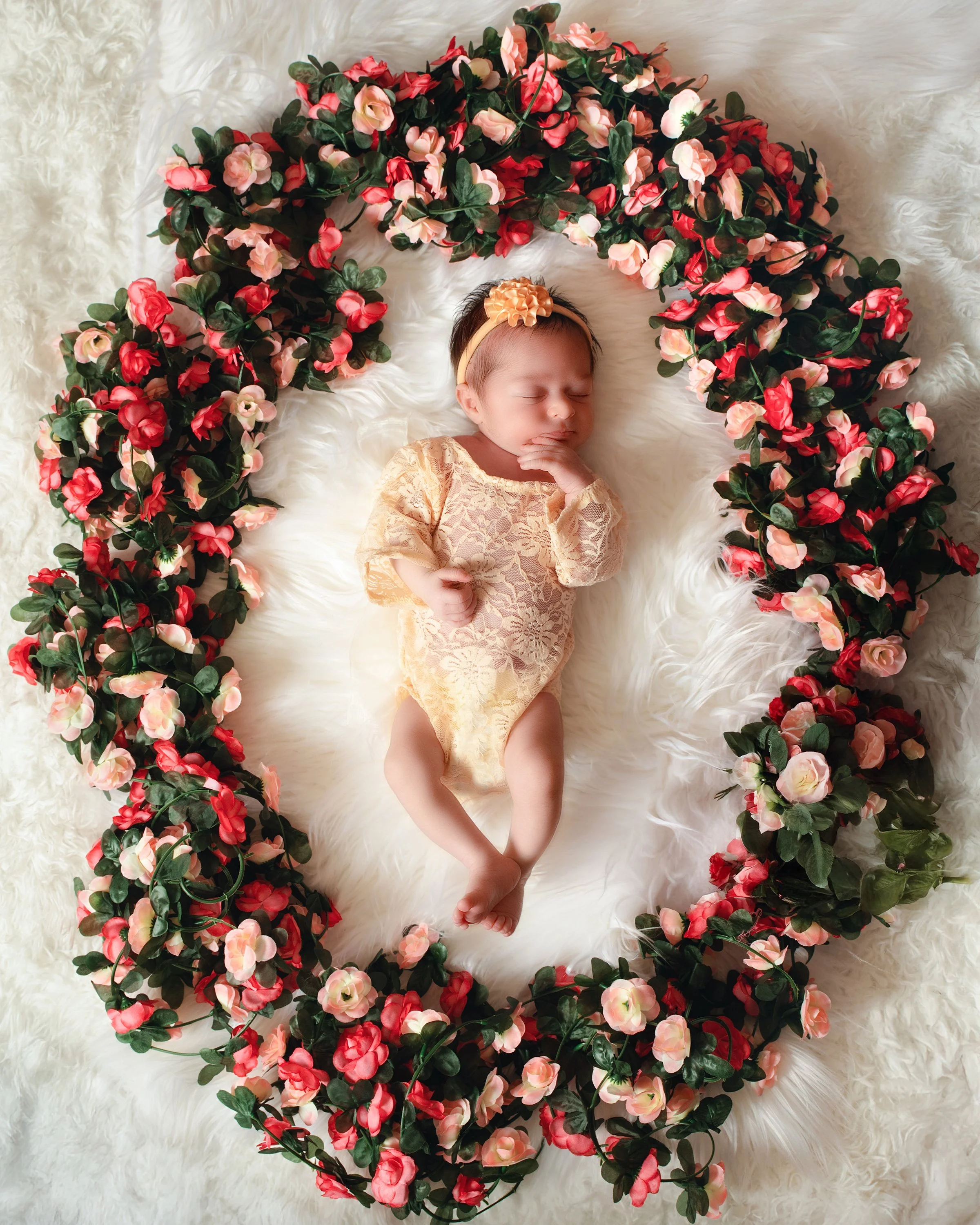 Styled newborn portrait with floral details