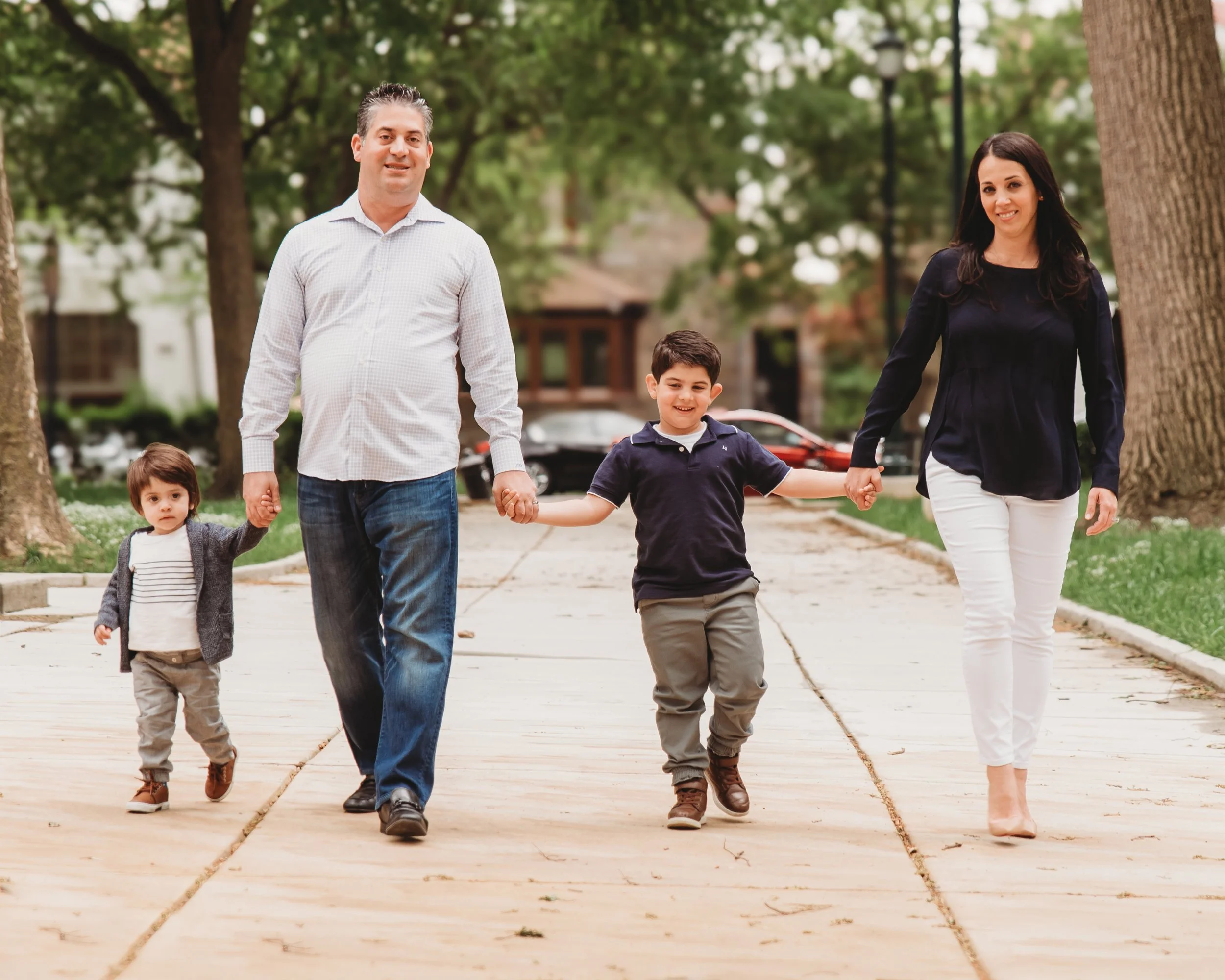 Family walking together during an outdoor portrait session in South Jersey
