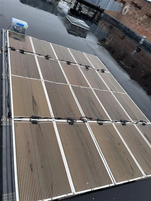 Rows of ORENgE flexible panels installed on a flat roof