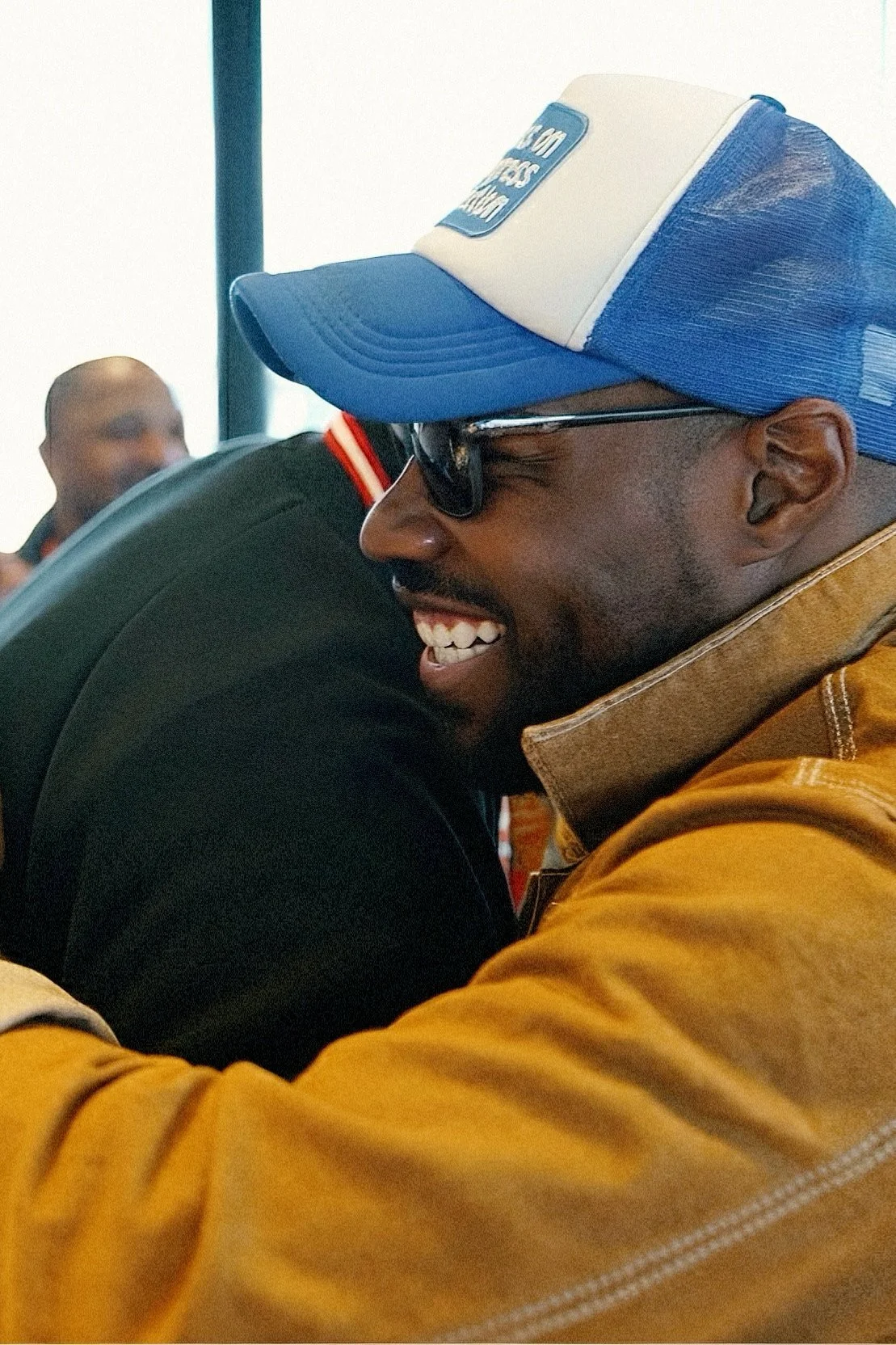 CJ Johnson smiling, greeting a friend