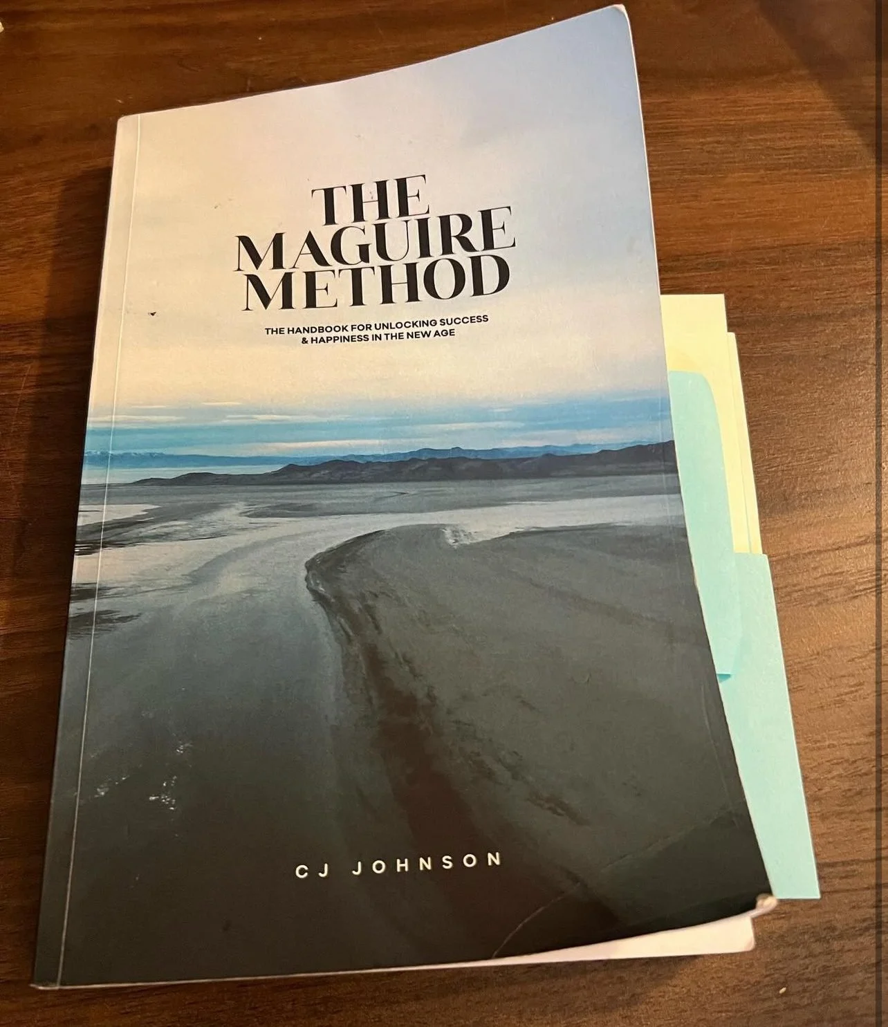 A well-read copy of The Maguire Method with sticky-note tabs
