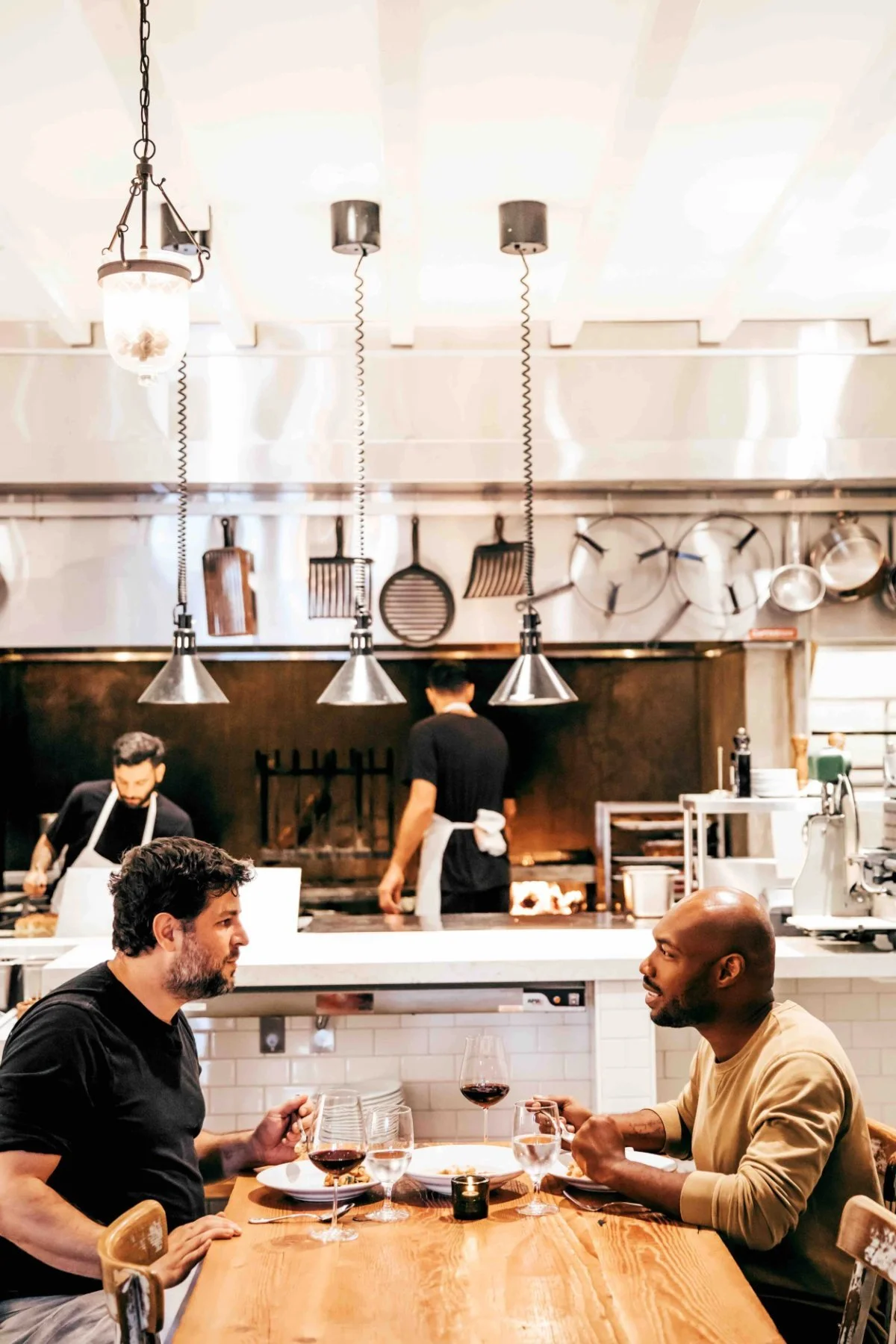 CJ Johnson at dinner in an open kitchen restaurant